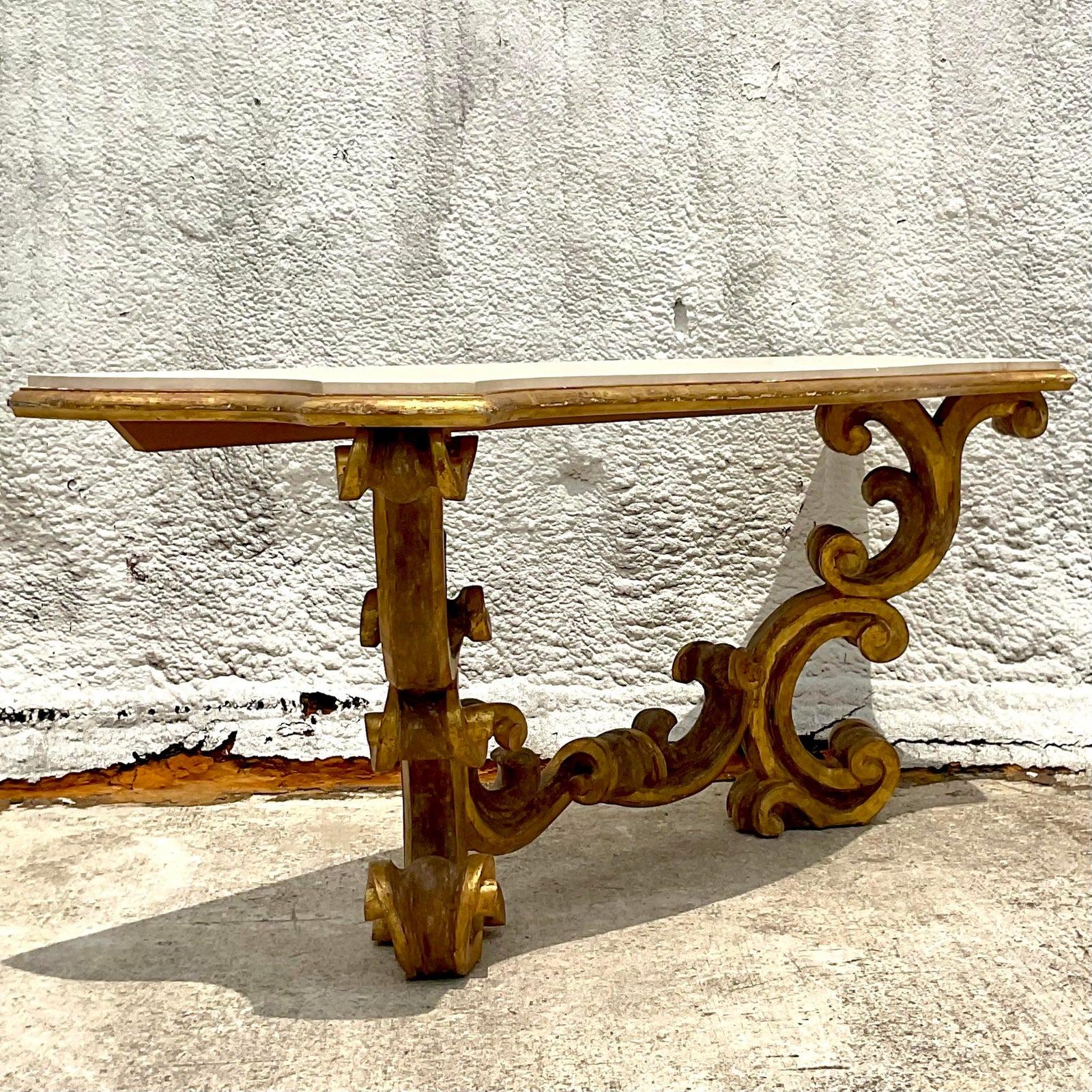 Elevate your space with this Vintage Rococo Gilt Wall Mount Console Table. Exuding opulence and charm, this table features intricate gilt detailing and a wall-mount design, bringing a touch of European-inspired luxury to your American-style décor.