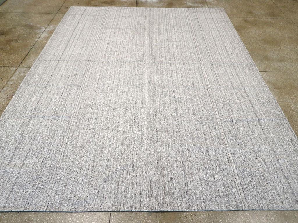 This Mid-20th century Turkish Flatweave Kilim rug, measuring 9' 11