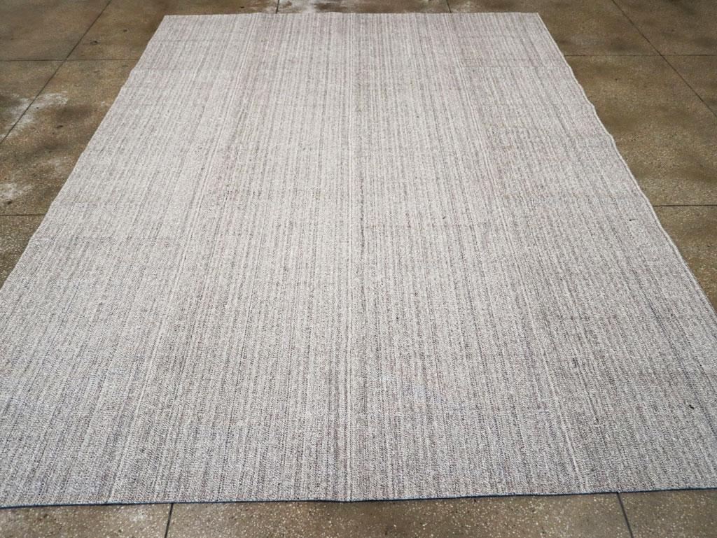 This Mid-20th century Turkish Flatweave Kilim rug, measuring 10' 1
