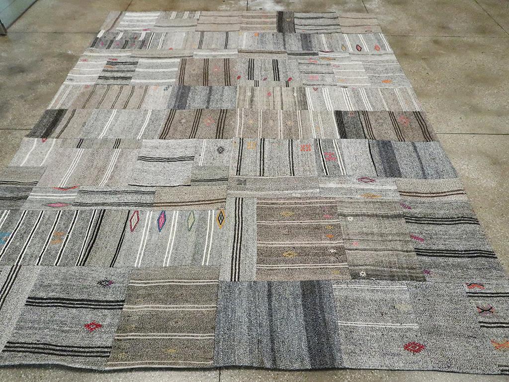 This Mid-20th century Turkish Flatweave Kilim rug, measuring 10' 3