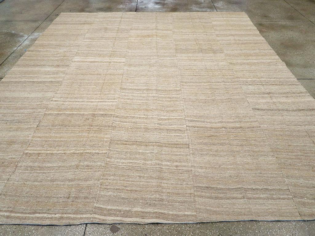 This Mid-20th century Turkish Flatweave Kilim rug, measuring 10' 5