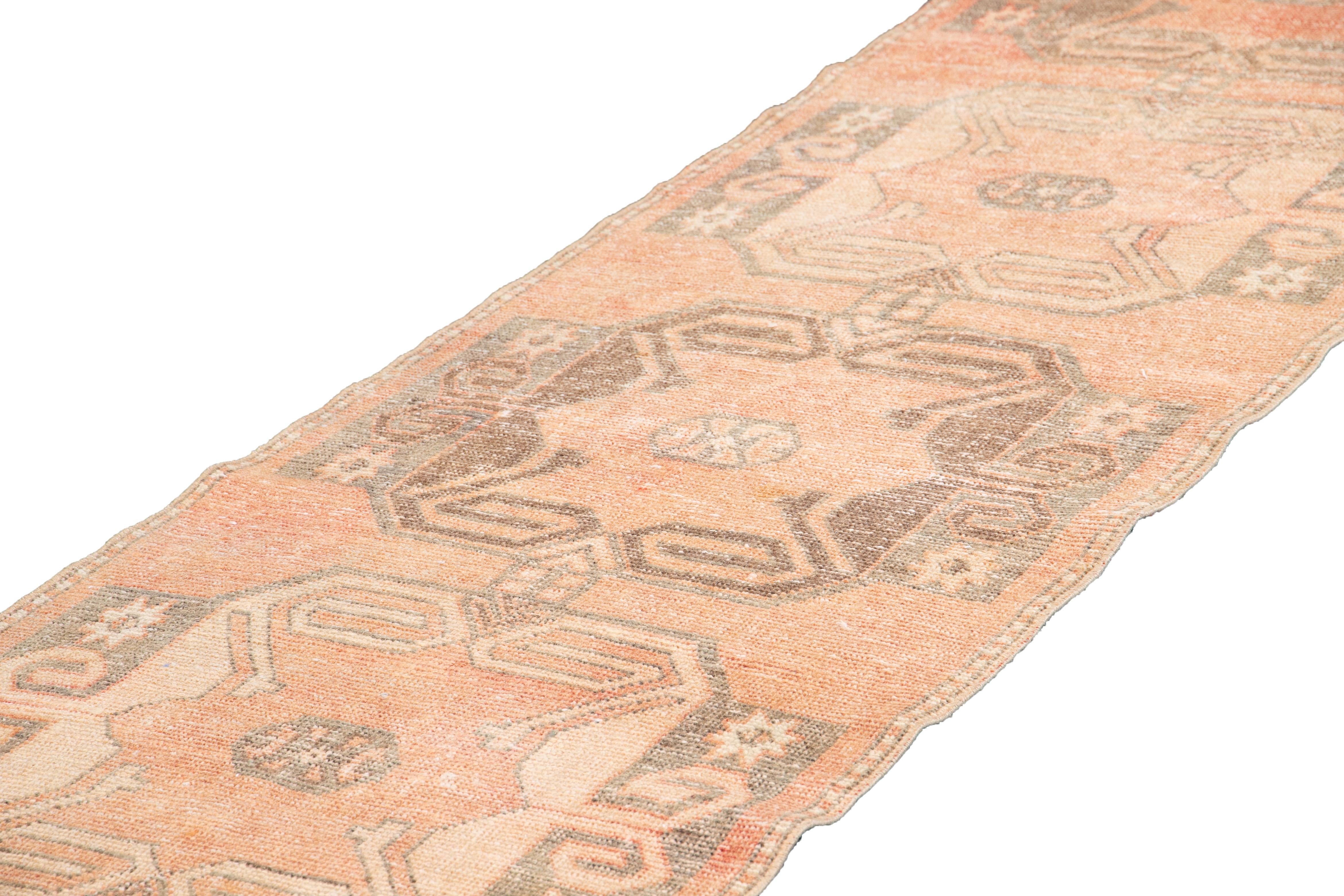 Beautiful Vintage Runner Rug, hand-knotted wool with a peach field, tan accents in a multi medallion design.
This rug measures 2' 11