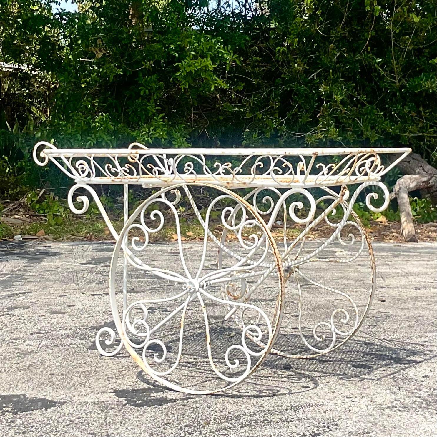 Unleash the spirit of mid-century American elegance with our Vintage MCM Wrought Iron Bar Cart. Crafted with precision and style, this iconic piece embodies the timeless allure of mid-century modern design. With its sleek lines and durable wrought