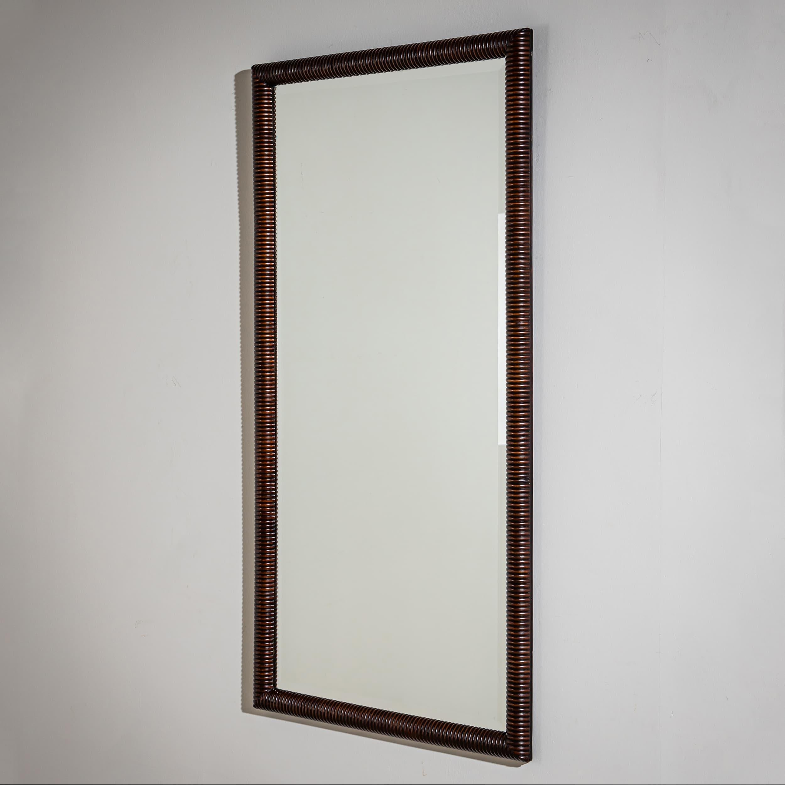 Rectangular wall mirror featuring a sculptural, ribbed solid walnut frame with softly rounded and wavy contours.