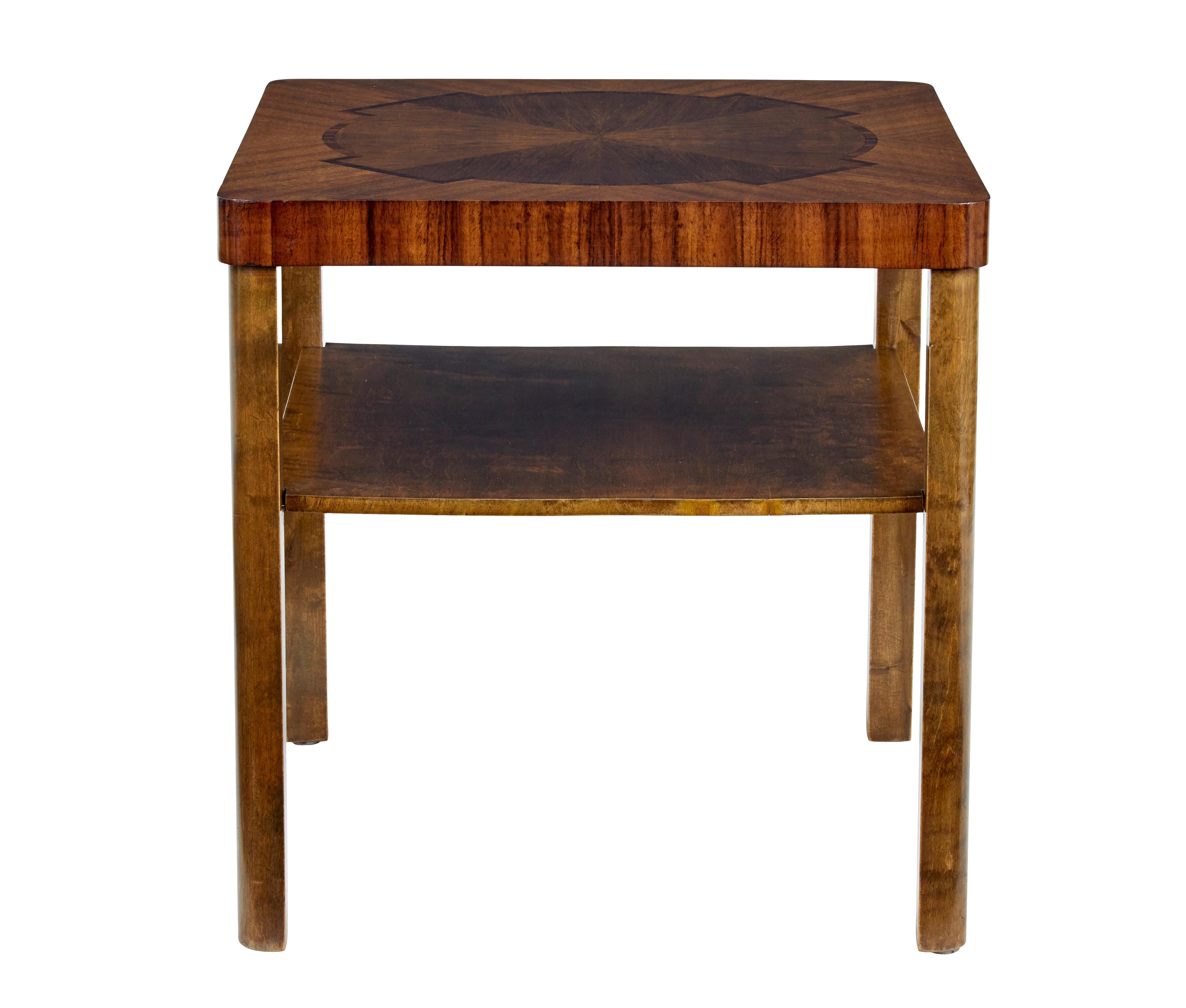 Mid 20th century walnut and birch inlaid coffee table circa 1950.

Square shaped coffee table with rounded edges.  Walnut top with palisander motif design to the top, with further palisander veneer around the top edge.

Shaped legs provide support