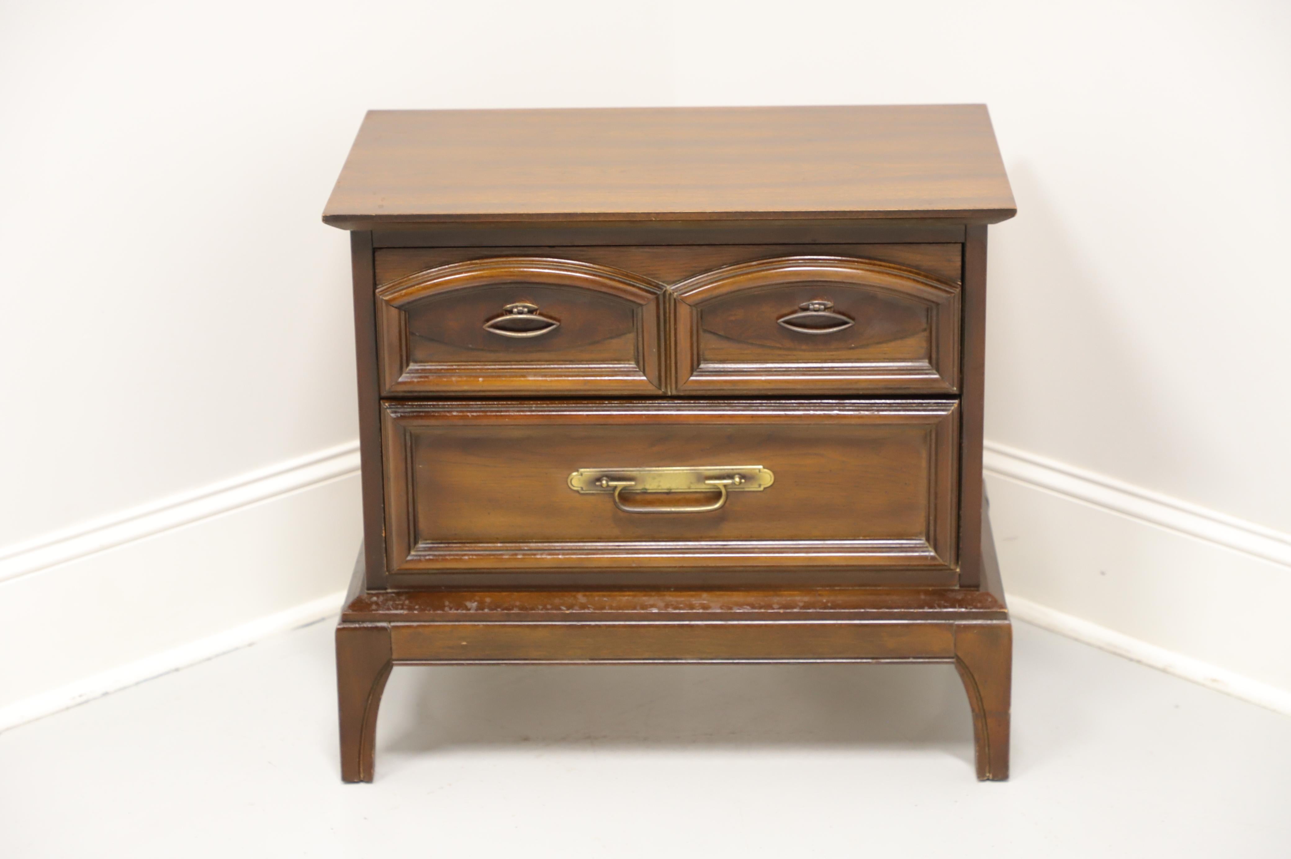 An Asian influenced Mid-Century nightstand, unbranded, similar quality to Thomasville. Walnut with brass hardware, burl accent to top drawer and splayed feet. Features two drawers of dovetail construction. Made in the USA, in the mid 20th