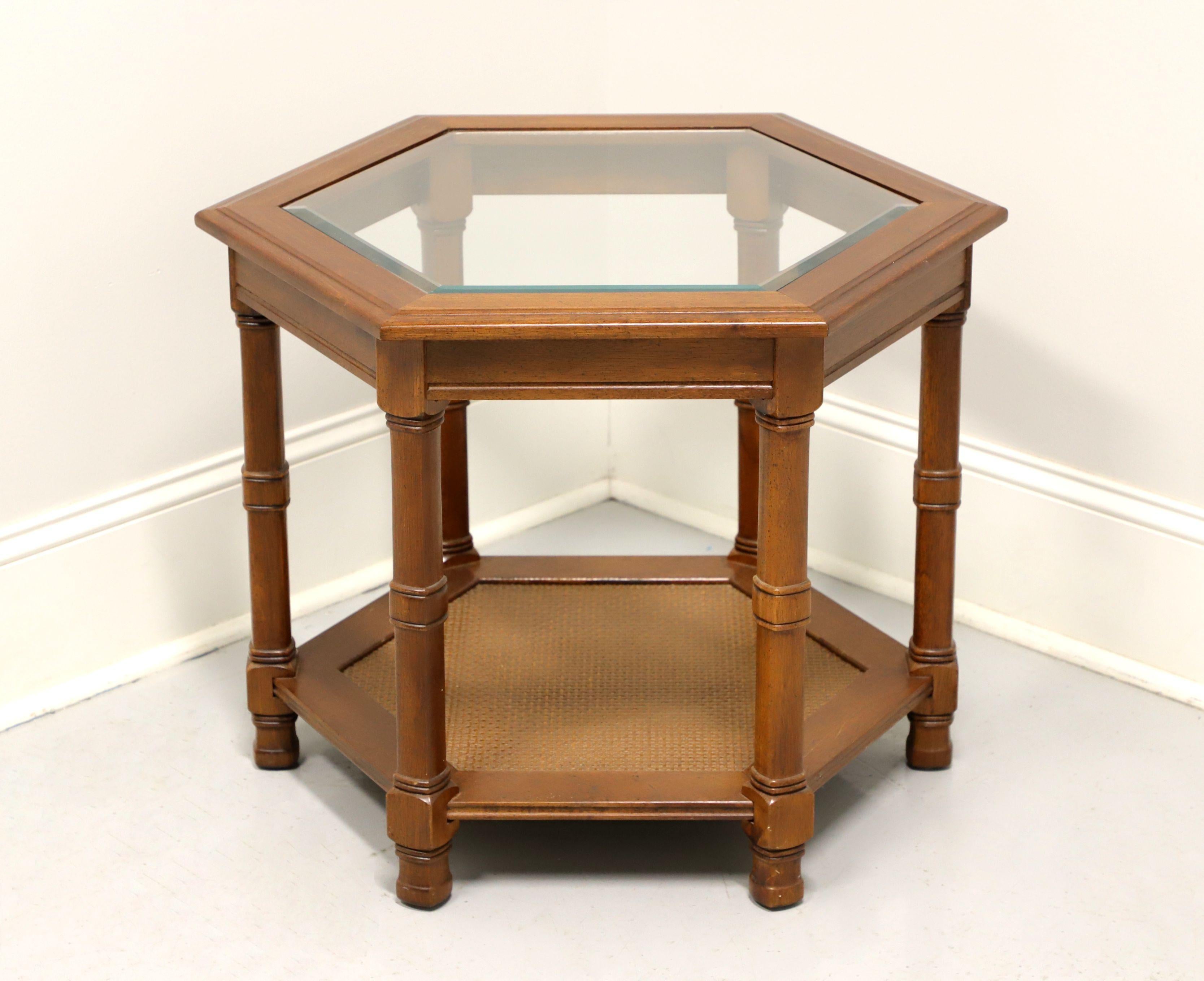 A mid 20th century hexagonal shaped glass top accent table, unbranded, similar quality to Henredon. Walnut with beveled glass top, six legs and caned undertier shelf. Made in the USA.

Measures: 27.5 W 23.75 D 20.75 H

Exceptionally good