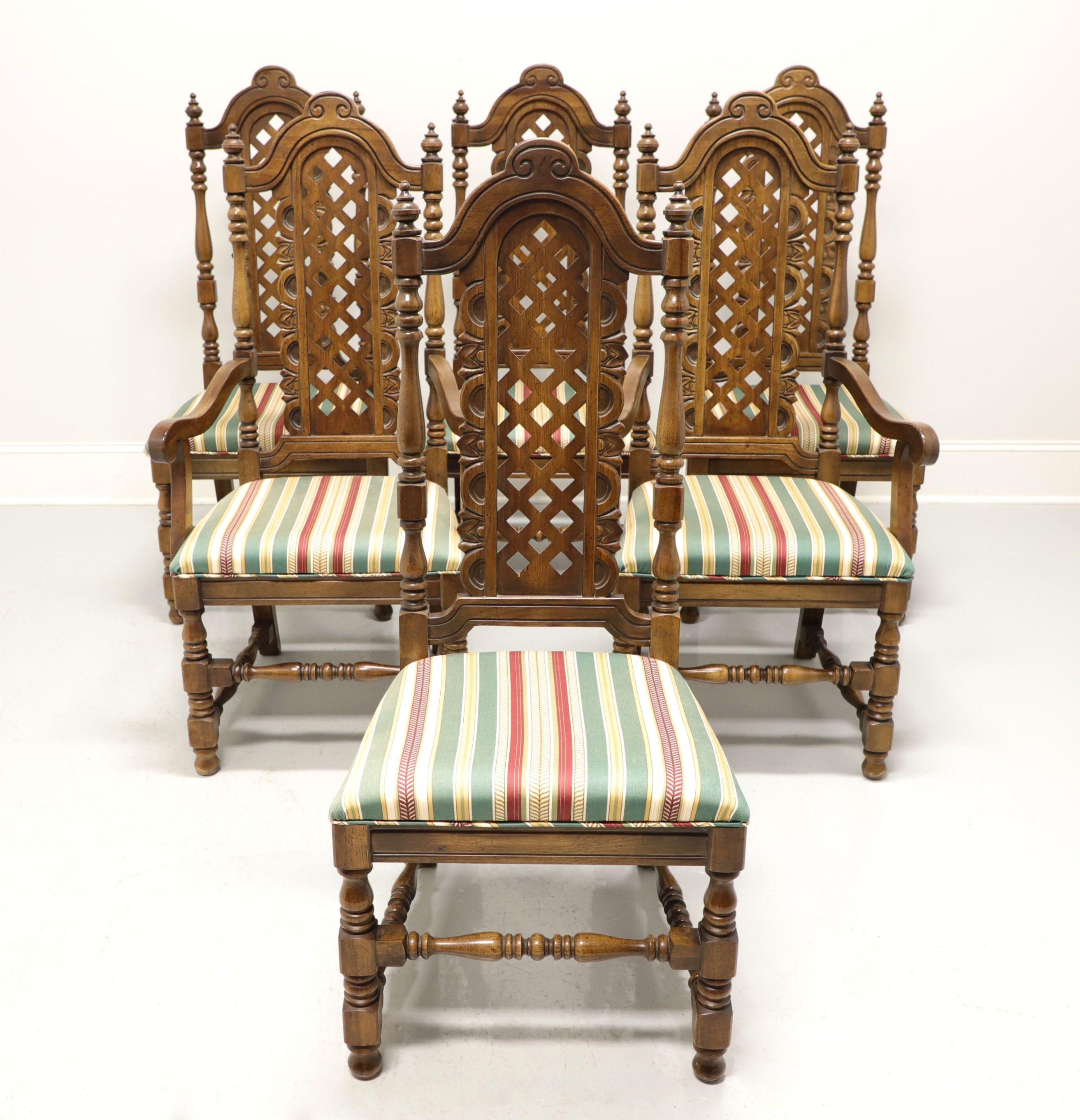 A set of six Spanish Baroque style dining chairs, by Flair for Hibriten (now Bernhardt). Solid walnut, rounded carved crest rail, turned post backs with finials & lattice center back rest, stripe fabric upholstered seat, turned legs and stretchers.