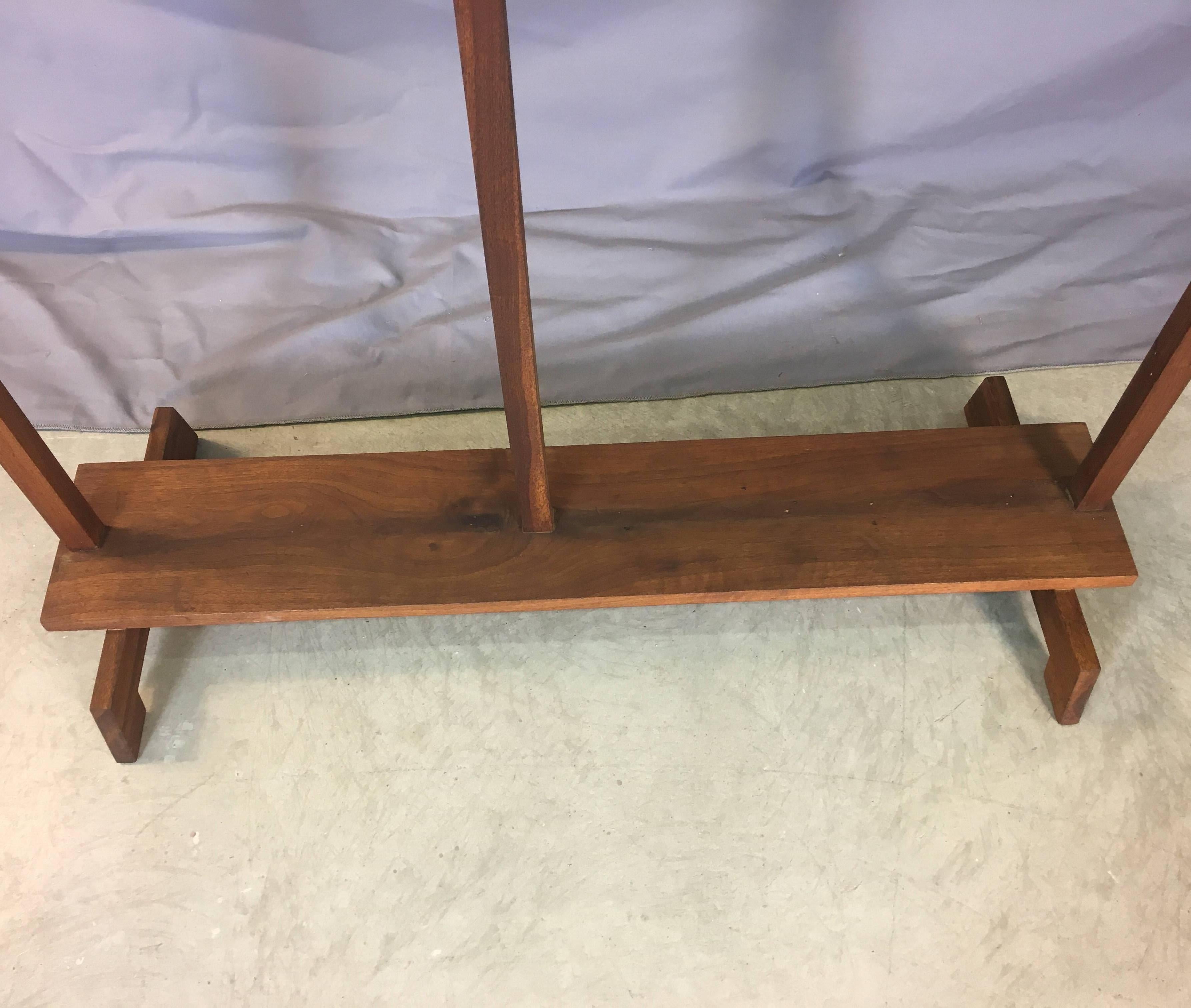 Vintage mid-20th century walnut wood display shelf with three built-in shelves. Fully restored. Left side is open to hang an item. The right side bottom shelf is 31” up from the floor and the other shelves are 11.5” apart. Each shelf is 22” W x 7”