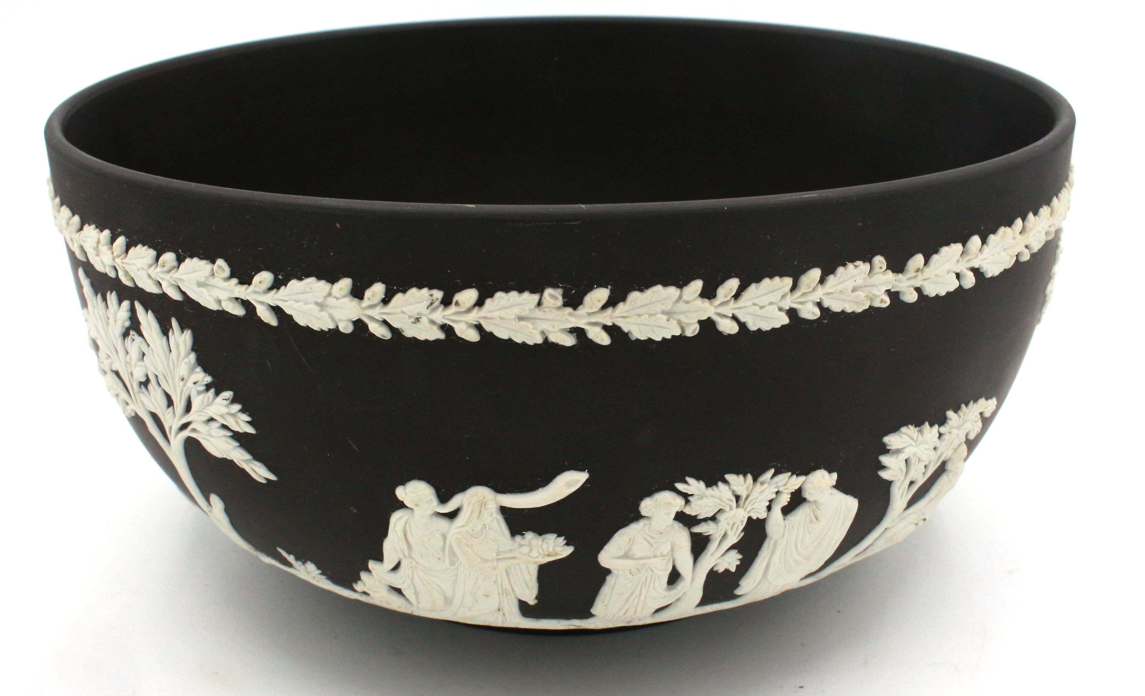 Wedgwood basalt fruit bowl, mid-20th century. Surrounded by applied Greco-Roman figures with tributes of fruits & flowers. Marked Made in England, Wedgwood, K864.
7 5/8