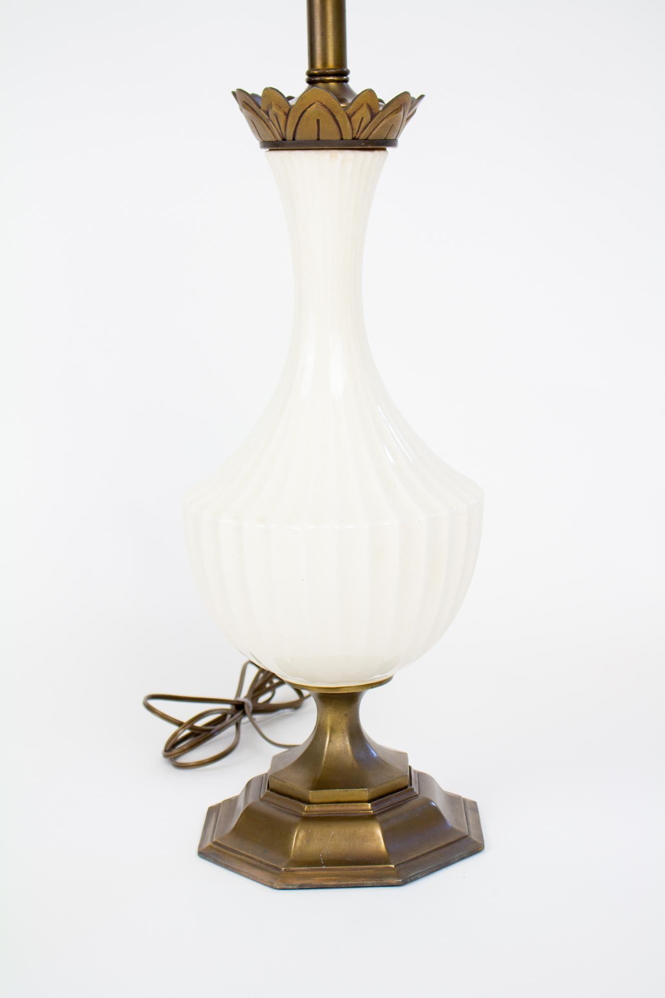 Mid 20th century crackle glaze table lamp. Crackle glaze porcelain and brass plated base and stem. Slender neck and scalloped edges. Surface cleaned and rewired. Porcelain in excellent condition, some wear to the brass plate finish on base. In