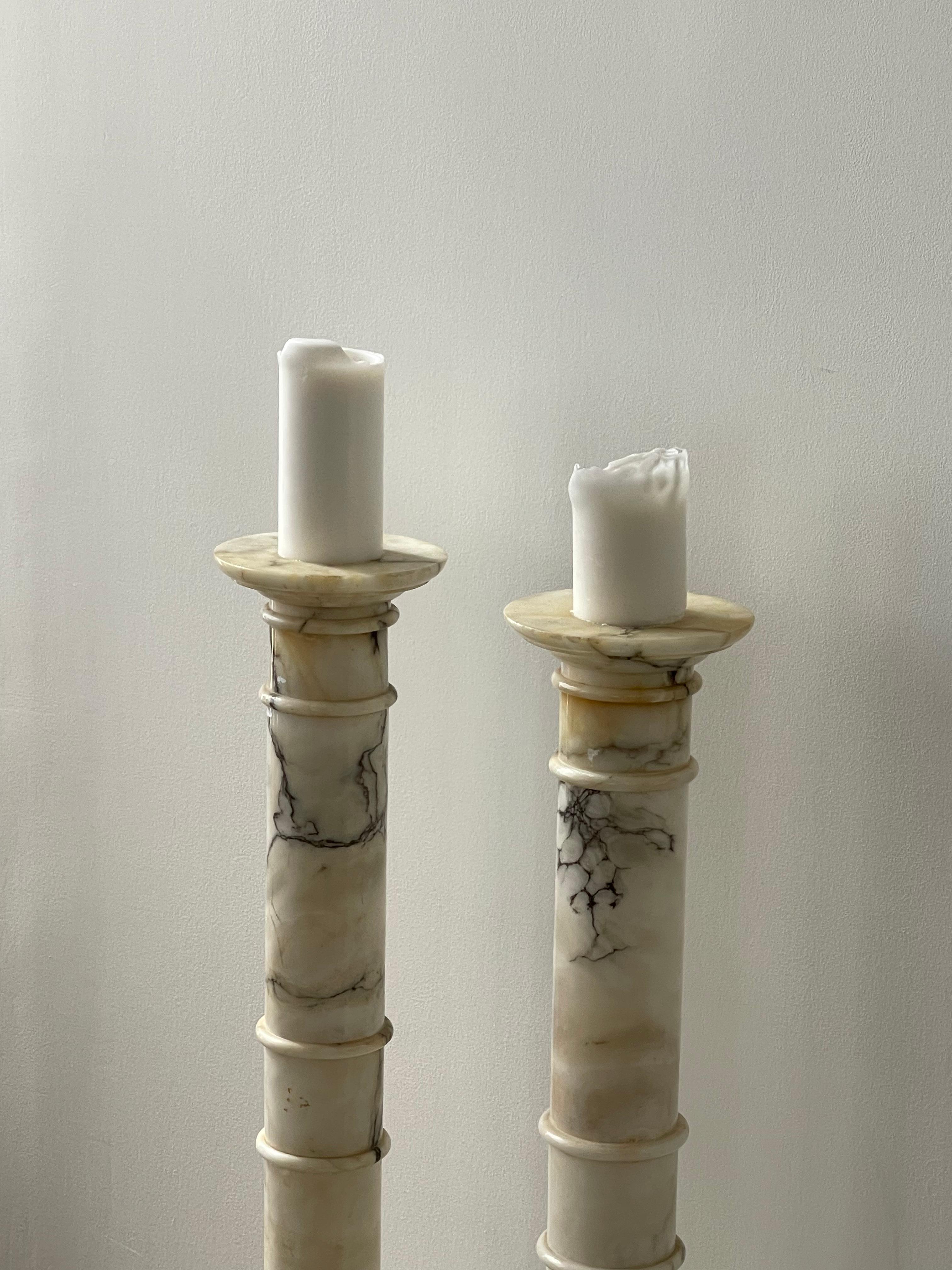 Mid-20th century white marble columns perfect for any type of display. We use them as amazing candlestick holders but can be used as pedestals. Beautiful veins and classical design. Sold individually.

Dimensions:
10