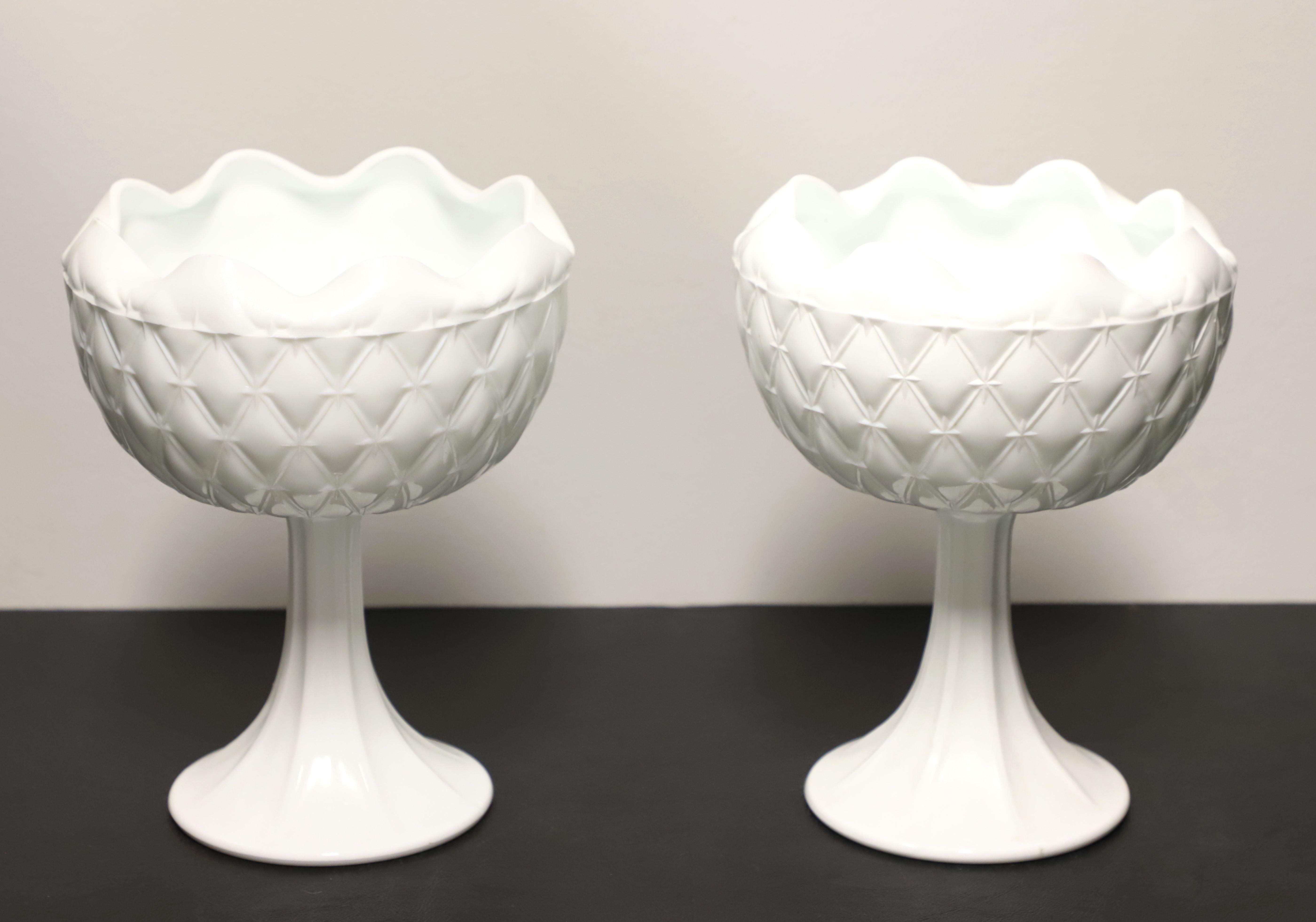 A pair of white milk glass pedestal table vases, unbranded. Pure white milk glass with a scalloped edge, cut diamond pattern to the bowl and a textured trumpet-shaped pedestal. Made in the USA, in the mid 20th Century.

Measures:   7w 7d 9h Each,