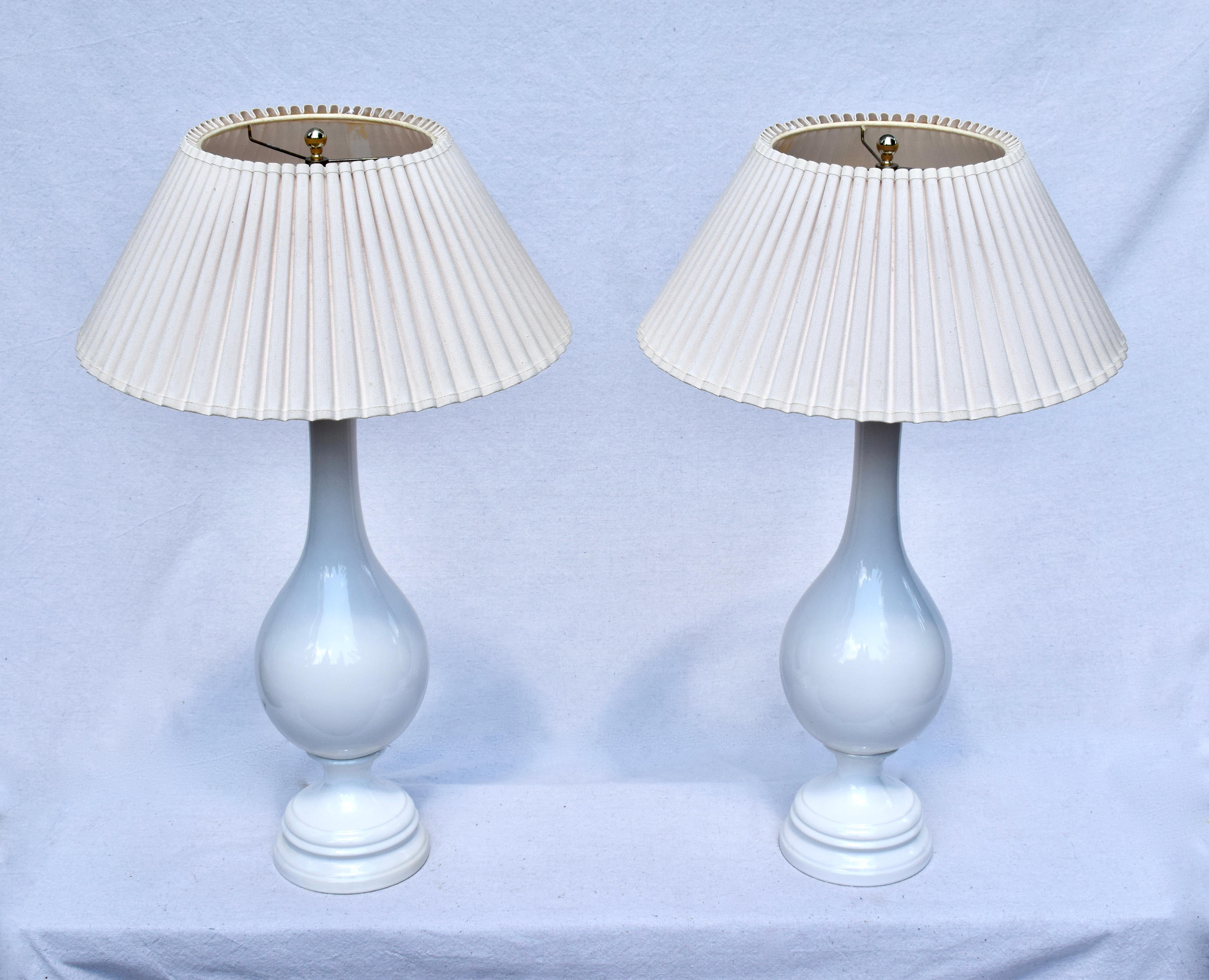 A pair of mid 20th C. porcelain table lamps with graceful swan like elongated necks. Sculpted shades are included.  New wiring. Height dimension of 31