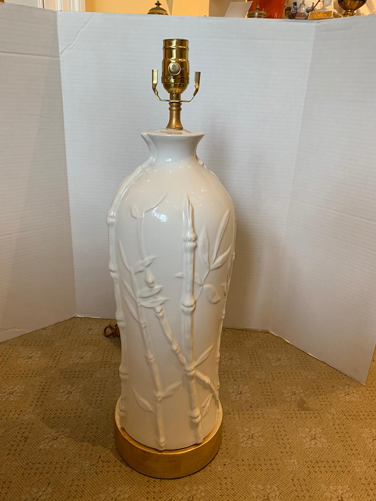 Mid-20th century white pottery lamp with bamboo motif on custom giltwood base.