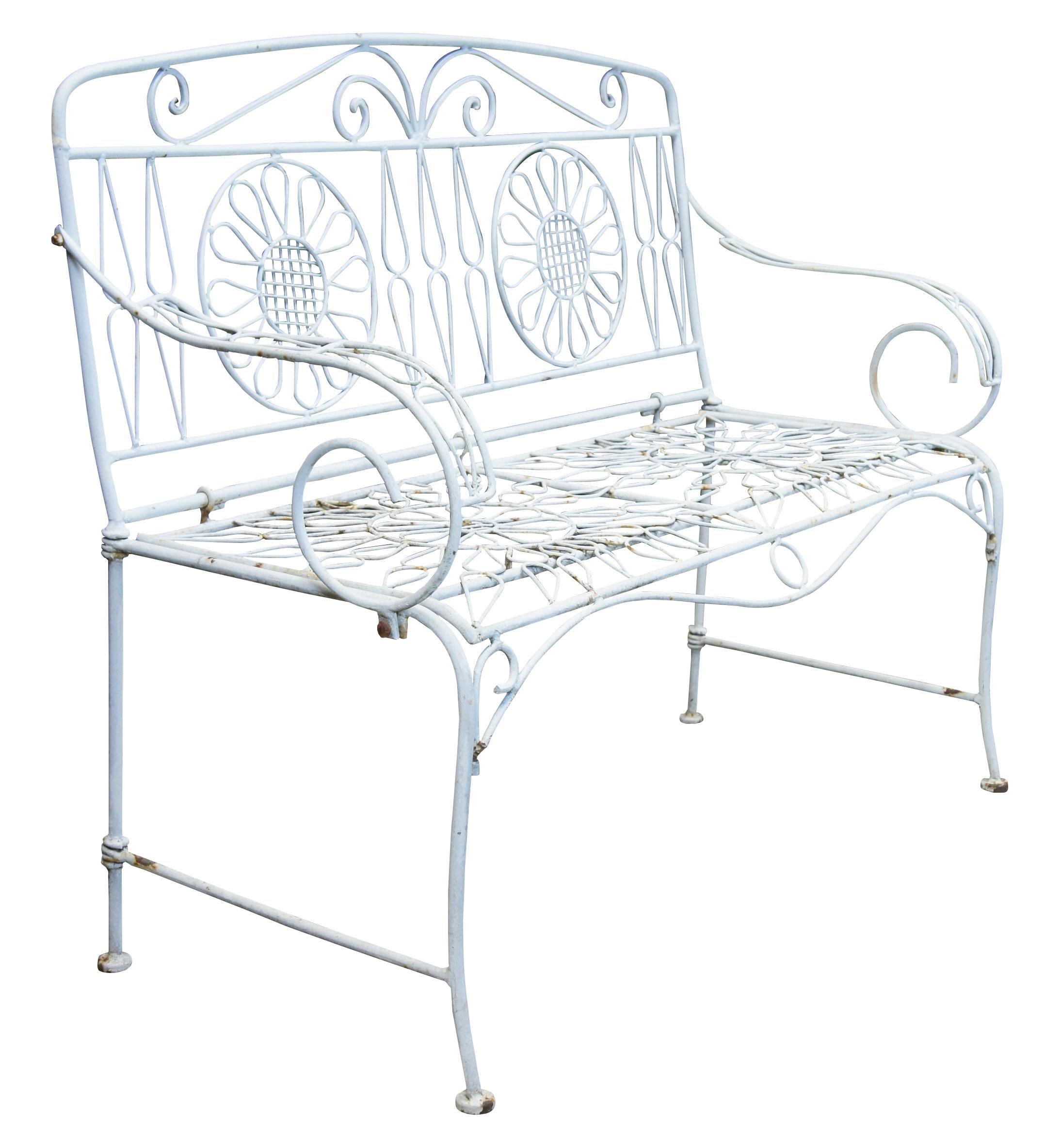 Mid 20th century iron outdoor bench/ settee. Features a neat interlaced design of flowers.
 