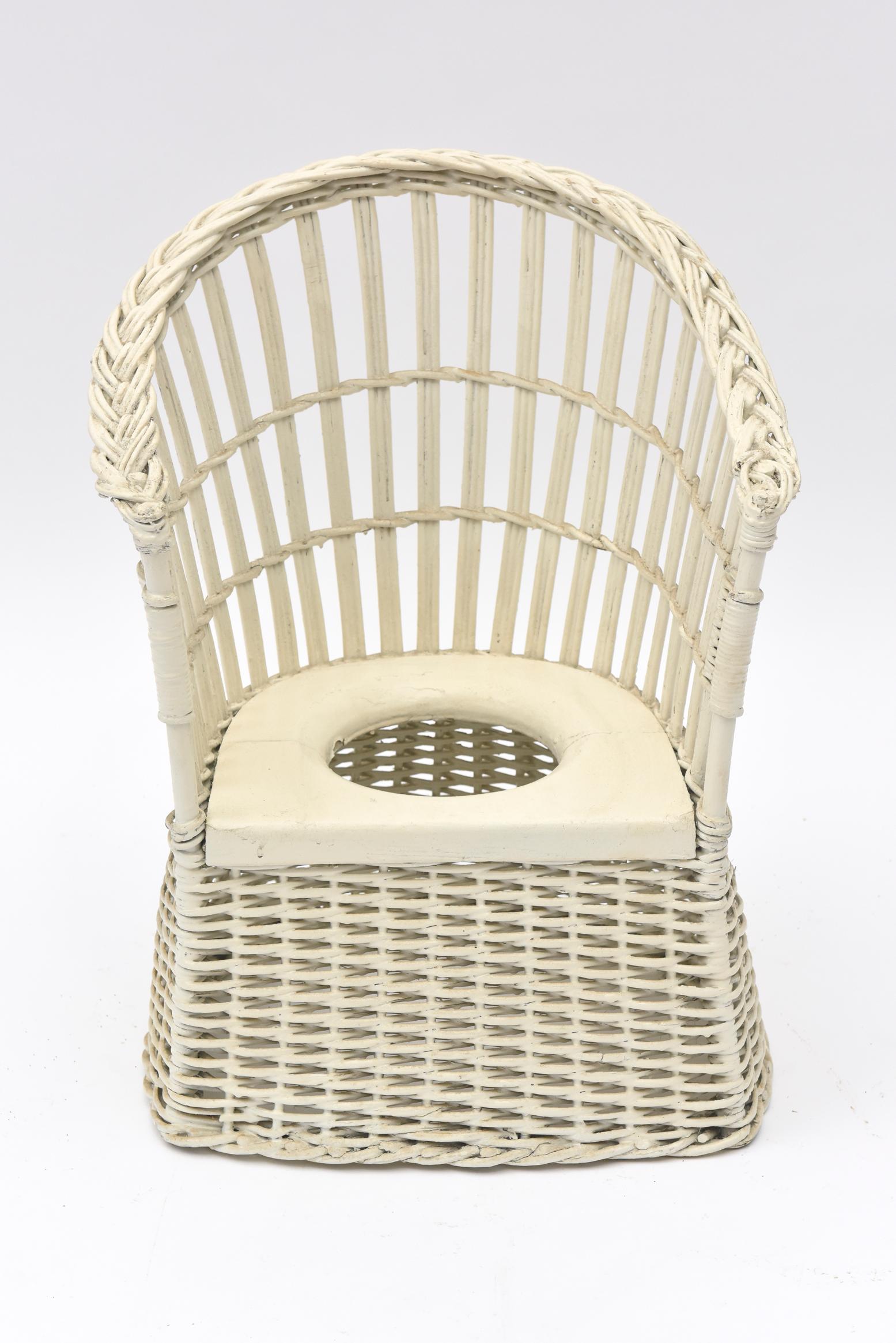 Painted white, this wicker potty seat is all about the early to mid-20th century when wicker was all the rage for nurseries. Although the original pot to catch the child's urine, etc., is missing, a newer larger pot can be easily found. The base of