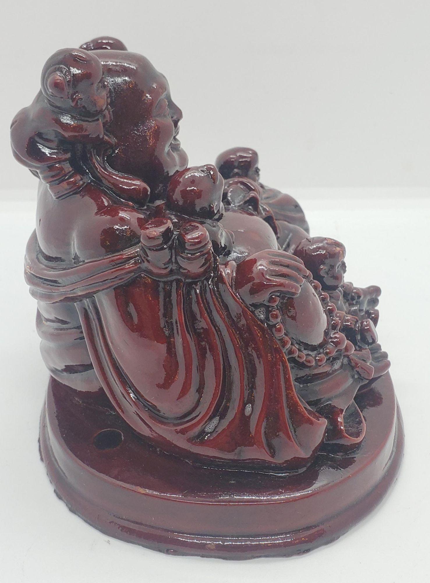 Mid Century polished Wooden Happy Buddha Sculpture surrounded by children.

