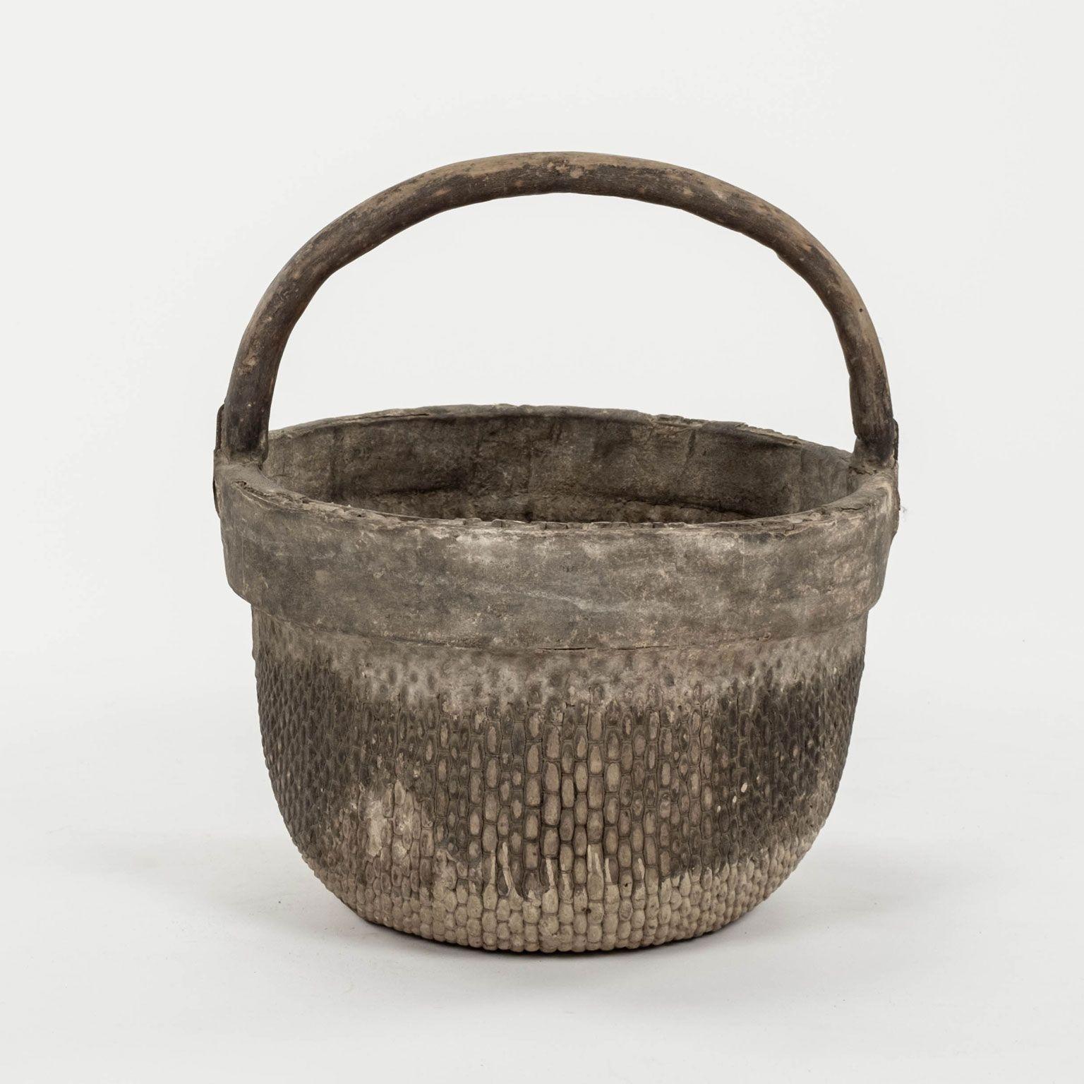 Mid-20th century woven Chinese rice basket with handle. Hand-woven willow with elm handle. Beautiful faded patina and texture from decades of wear. Three baskets available (see pictures). Baskets are sold individually and priced $1,400 each.

Note: