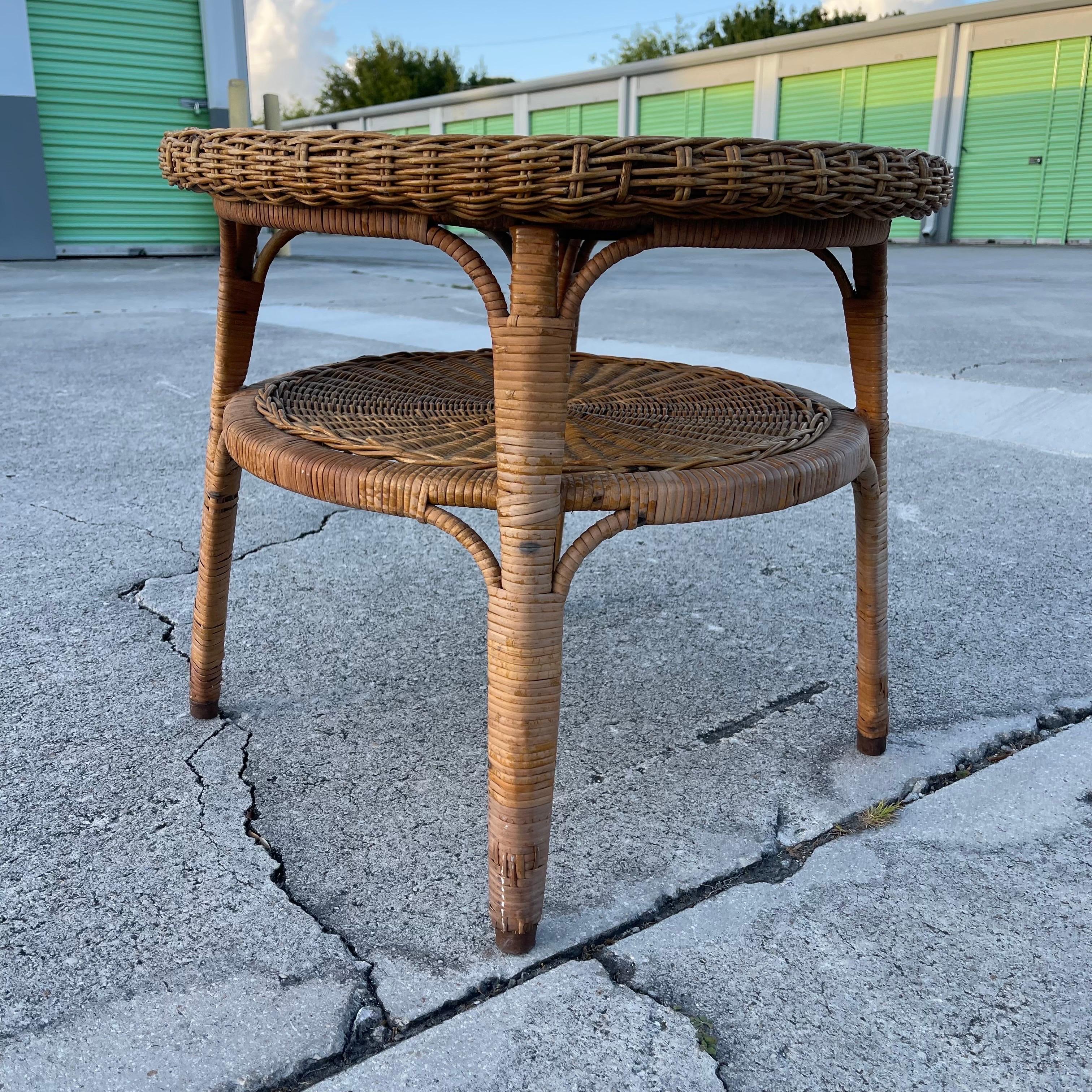 Charming small round coffee or side table made of handwoven wicker.