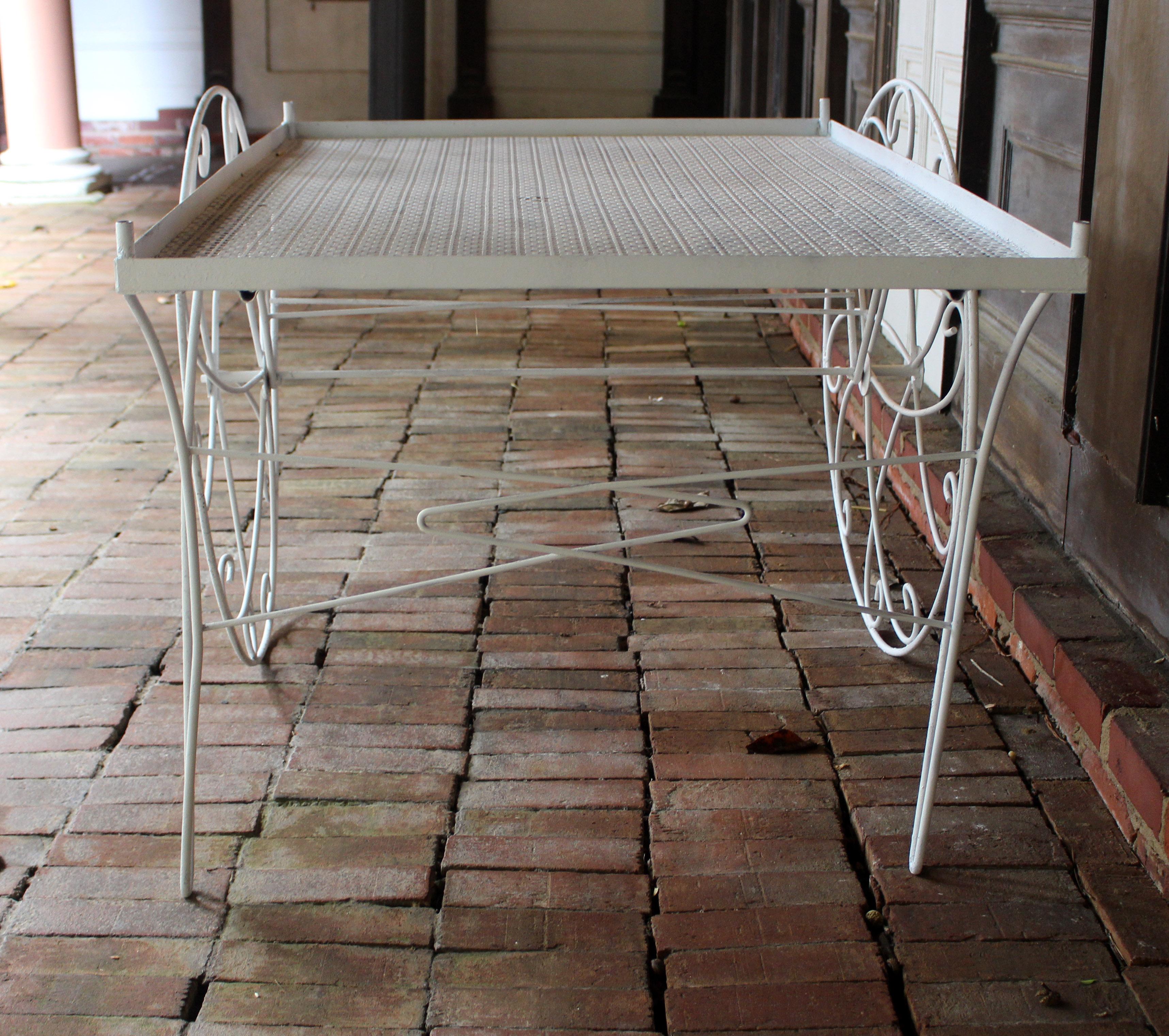 Mid-20th century garden cart of wrought iron, likely American. Modeled after Italian garden carts of the 19th century. Once with a canopy. Repainted white surfaces. Top: 30