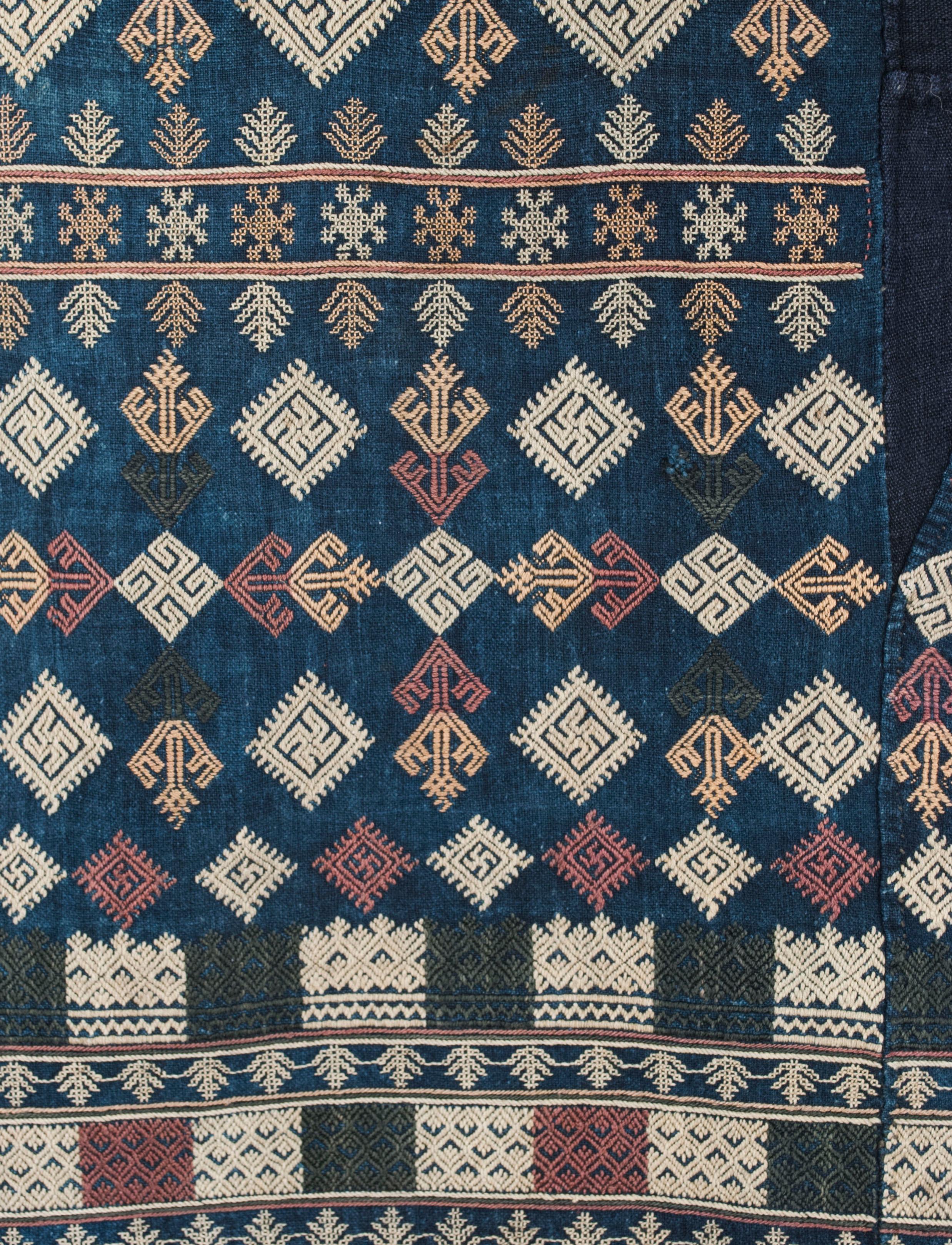 Mid 20th century Yao Group embroidered pants

The muted earth tones of the patterns on these embroidered pants are typical of the work done by the Yao ethnic group in northern Laos before the use of aniline dyes. The precision of the embroidery