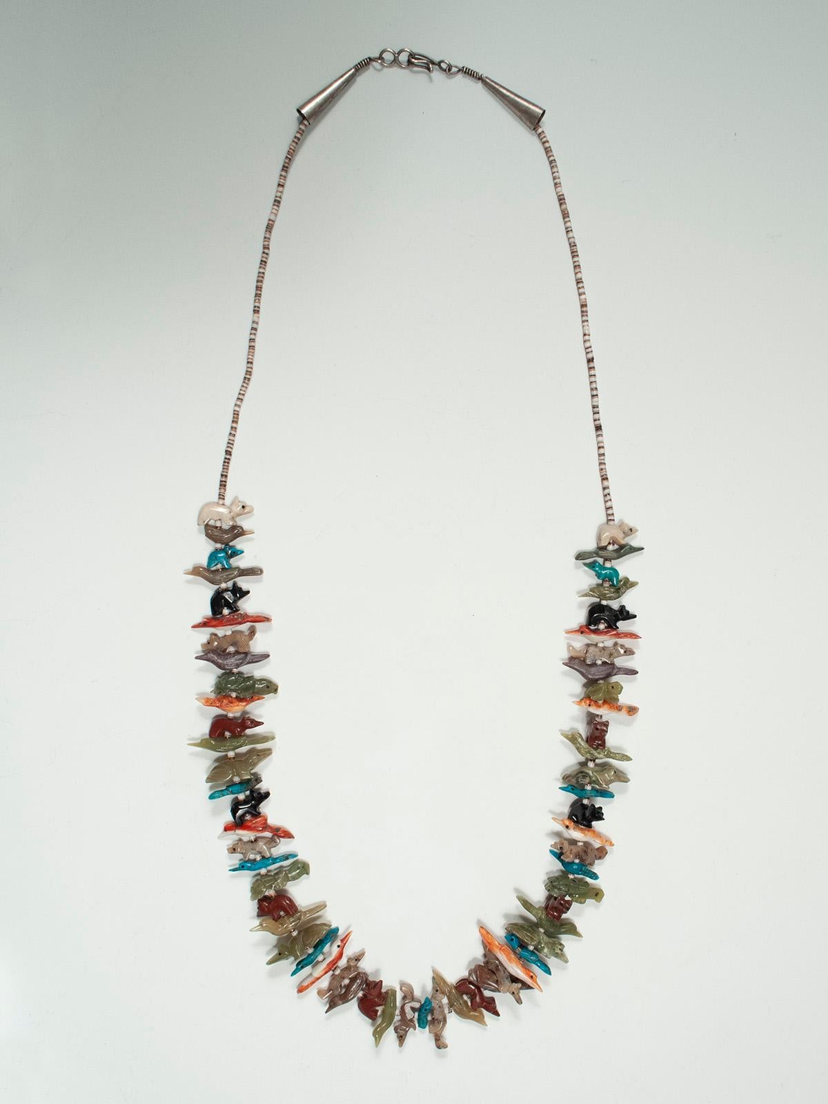 Mid-20th Century Zuni Single Strand Fetish Native American Necklace

A simple colorful single strand fetish necklace with birds, frogs, bears, turtles and a variety of other vermin and reptiles in a wide array of different stones. The closing is