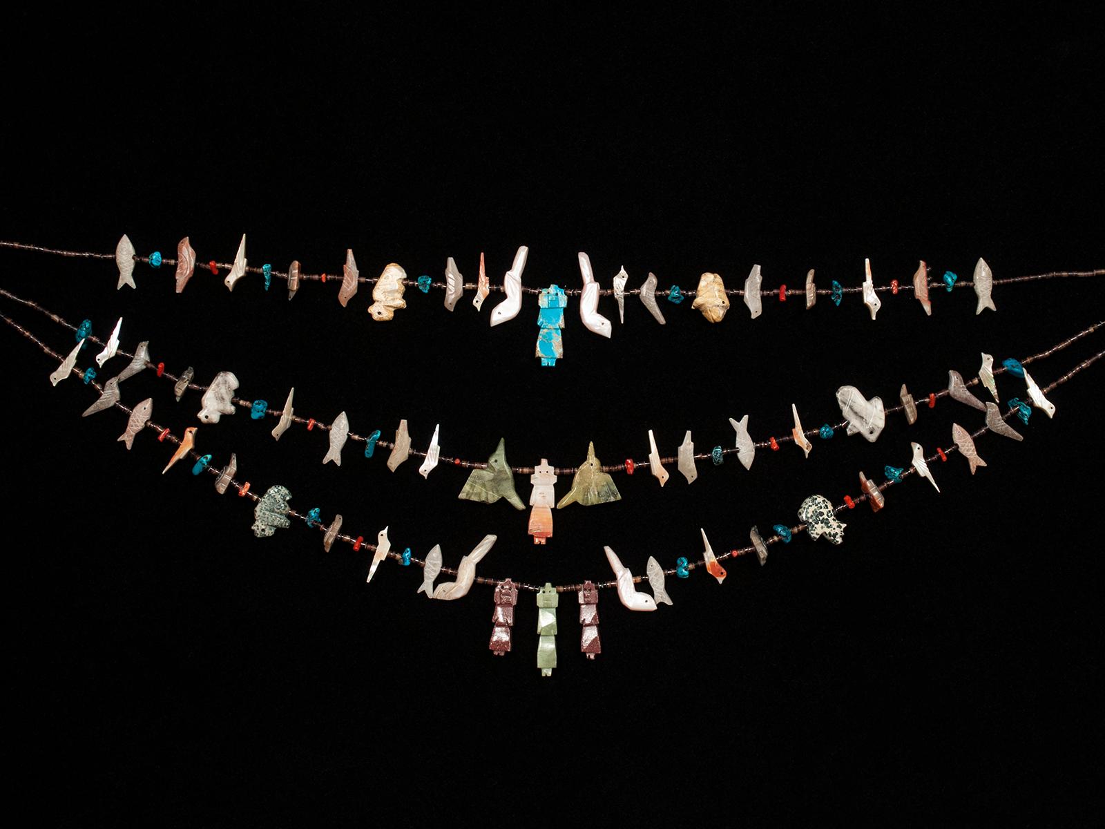 Mid-20th century Zuni triple strand Fetish native American necklace

A dramatic triple-strand fetish necklace is festooned with birds, fish, buffalo, and turtles, all anchored by five colorful corn goddesses. The closing is the standard hook and