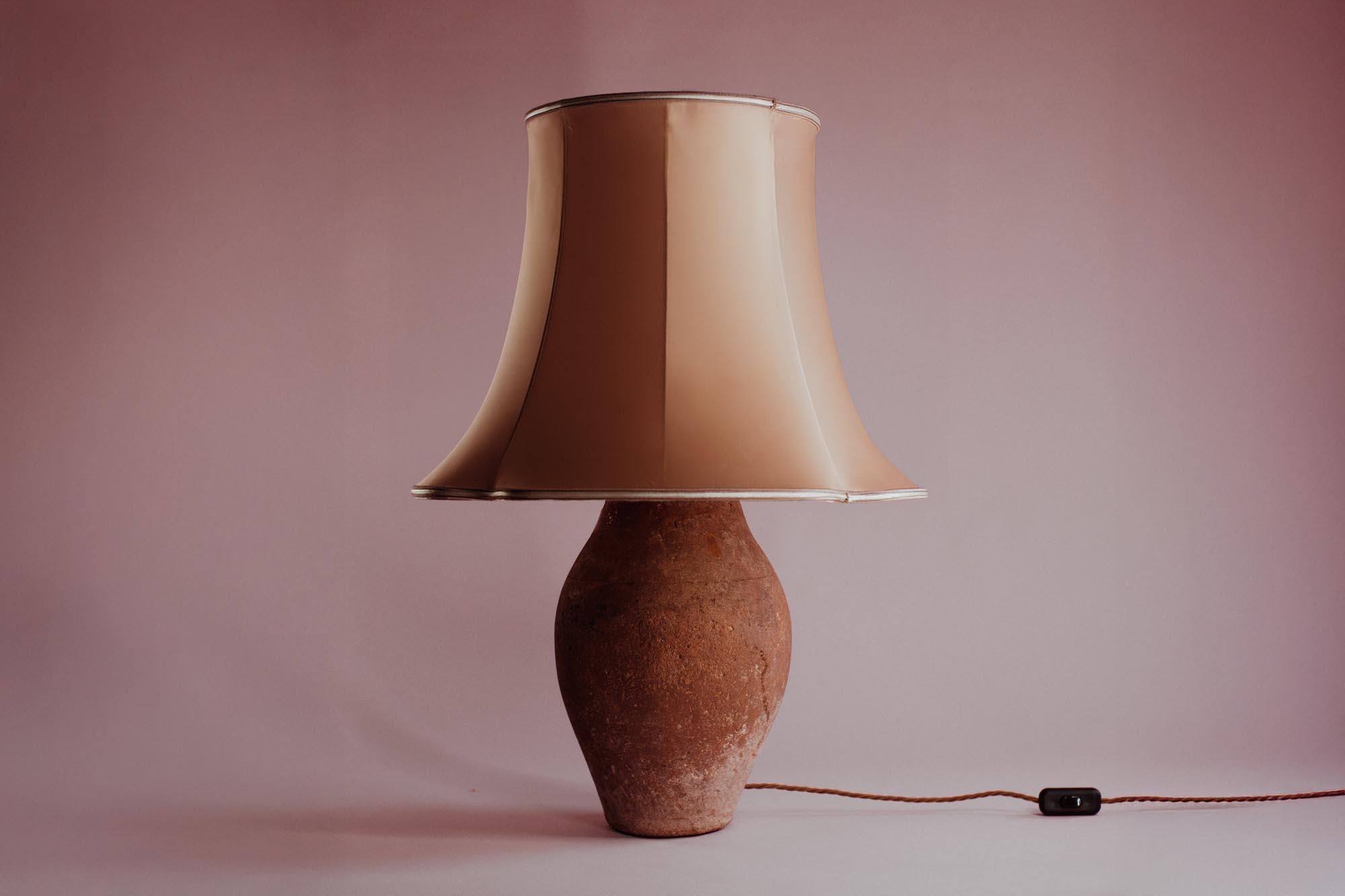 Overview
A mid-20th-century Mediterranean table lamp, handcrafted in Turkey from glazed terracotta. Once a utilitarian vessel, its distinctive worn glaze and earthen patina now bring elegance to modern interiors. Professionally converted in the UK,