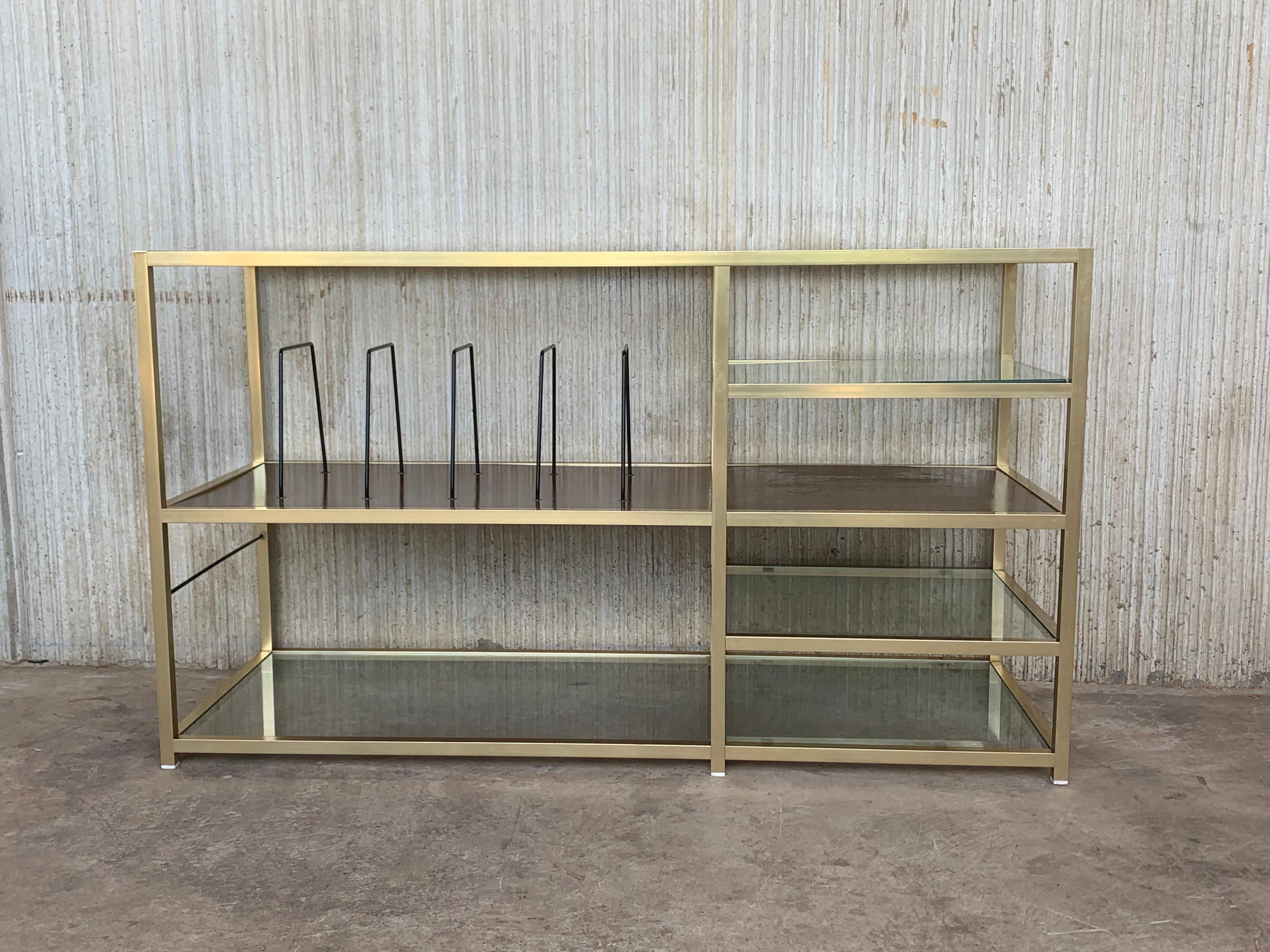 Brass console or étagère with glass shelves and vertical record album / book storage. The brass is bright and in good condition. 
 
