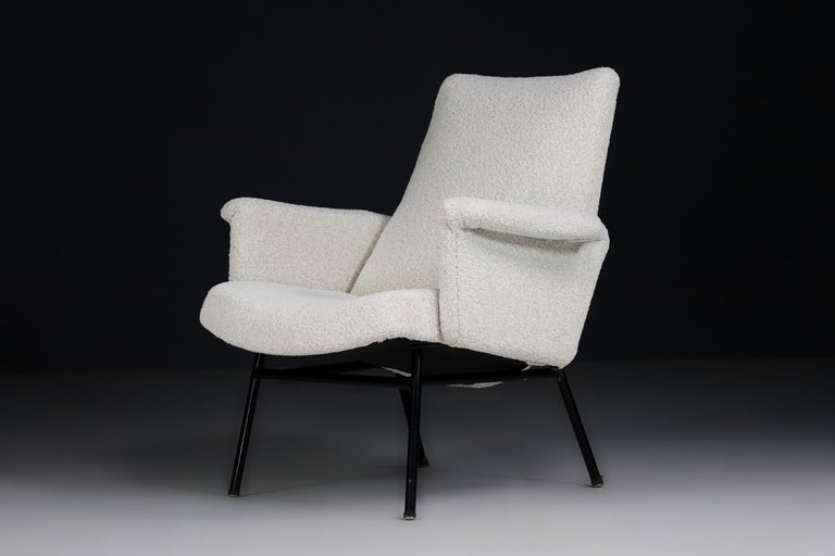 SK660 armchair designed by Pierre Guariche and manufactured by the French company Steiner, 1953 Tubular black lacquered metal feet and wooden frame foam-filled and reupholstered with a bouclé fabric. This arm chair would make an eye-catching