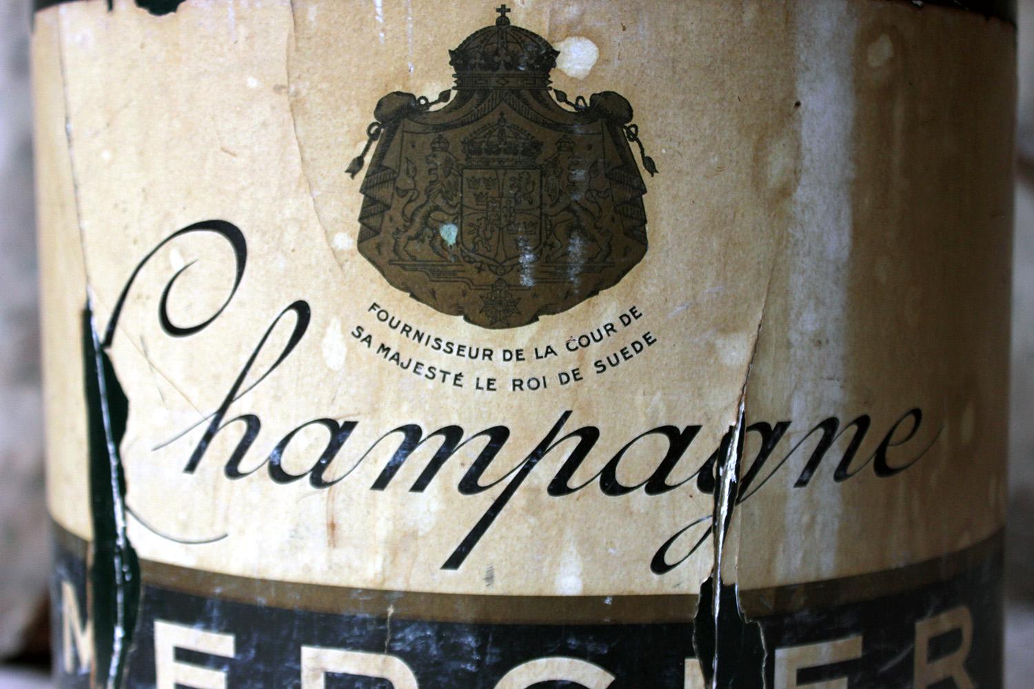 The oversized 1950s era plaster and papier mâché advertising bottle designed to be displayed in a shop window to advertise a bottle of French 1953 vintage A.C. Epernay, Champagne; now nicely worn with age, mid-20th century.

The bottle is in fair
