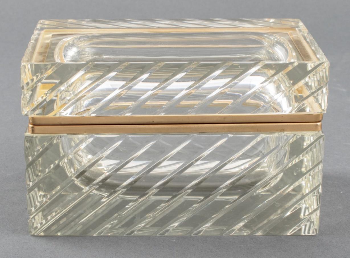 Mid-Century Modern gilt metal mounted cut crystal hinged trinket box, the exterior cut with diagonal lines, apparently unmarked. Approximately 1