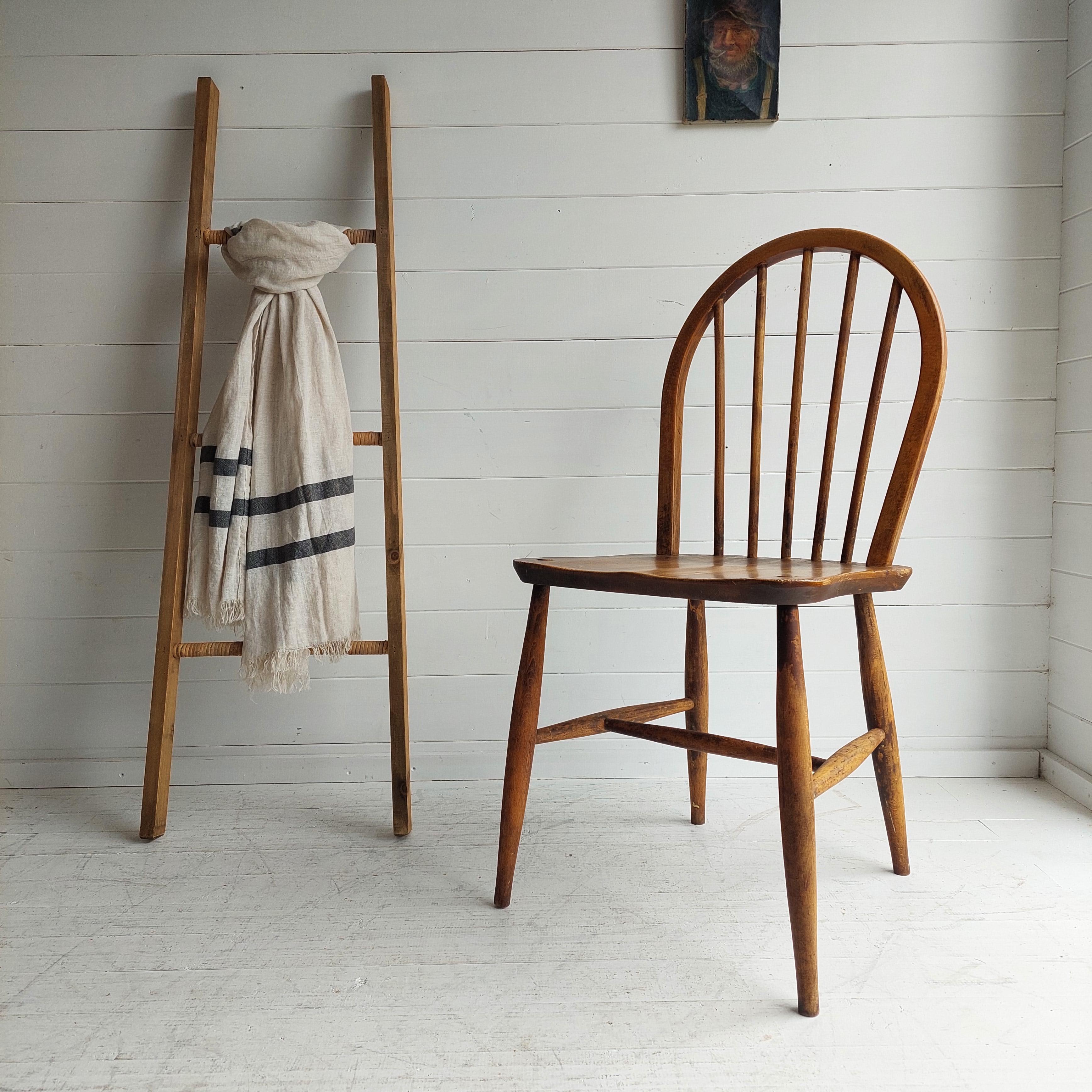 Ercol Windsor Kitchen chair 50s
Vintage Ercol Hoop Back Dining Chair Mid Century 

Ercol are an iconic British furniture company started by Lucian Ercolani, an Italian immigrant and Cabinet Maker in the 1930’s. 
They are known for their elegant