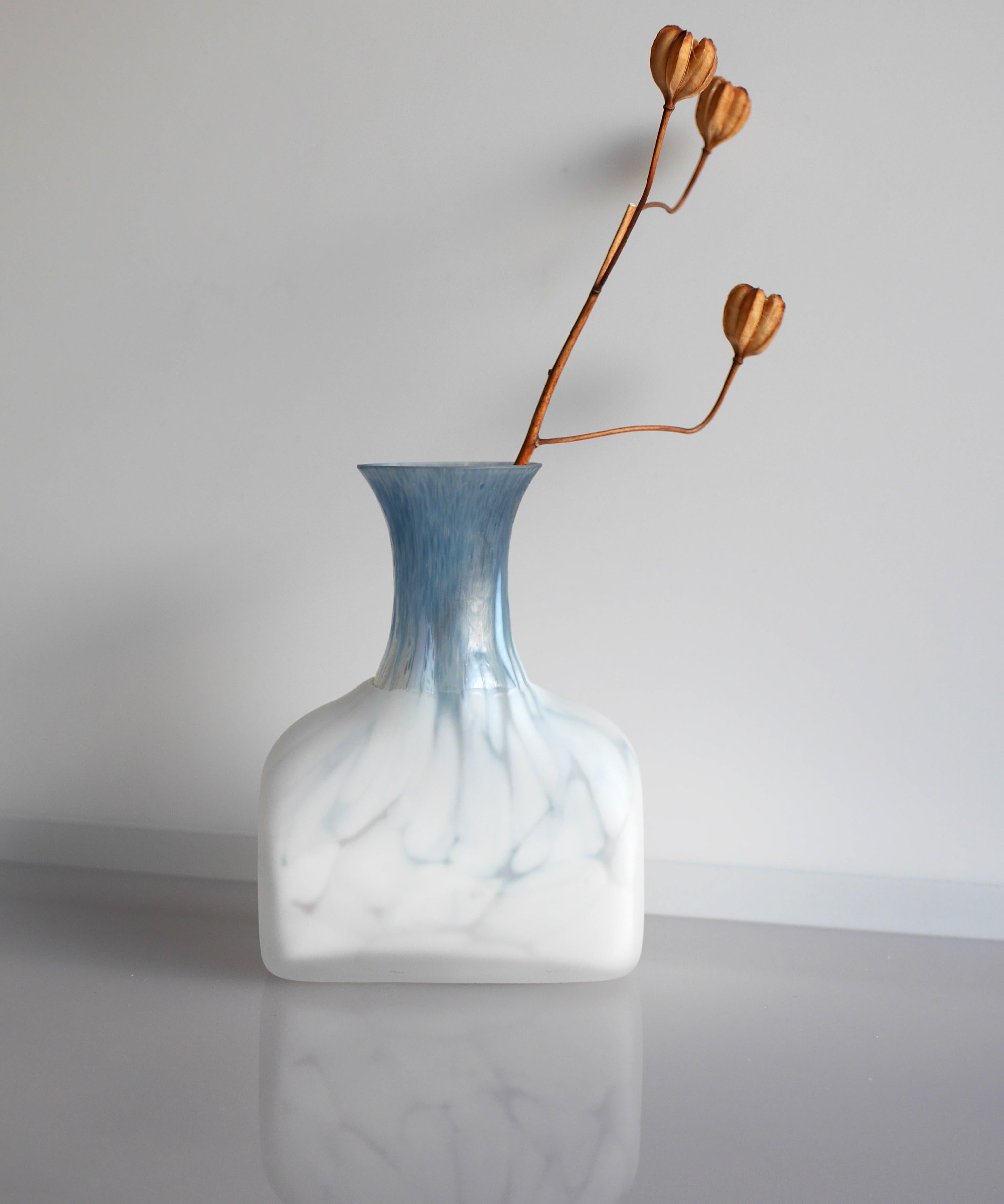 An amazing vintage cased glass vase handmade art glass, design by Monica Backström for Kosta Boda, Sweden. This is a very beautiful vase, it has a very special feeling to it, the neck has a thin layer of various shades of pale blue glass which