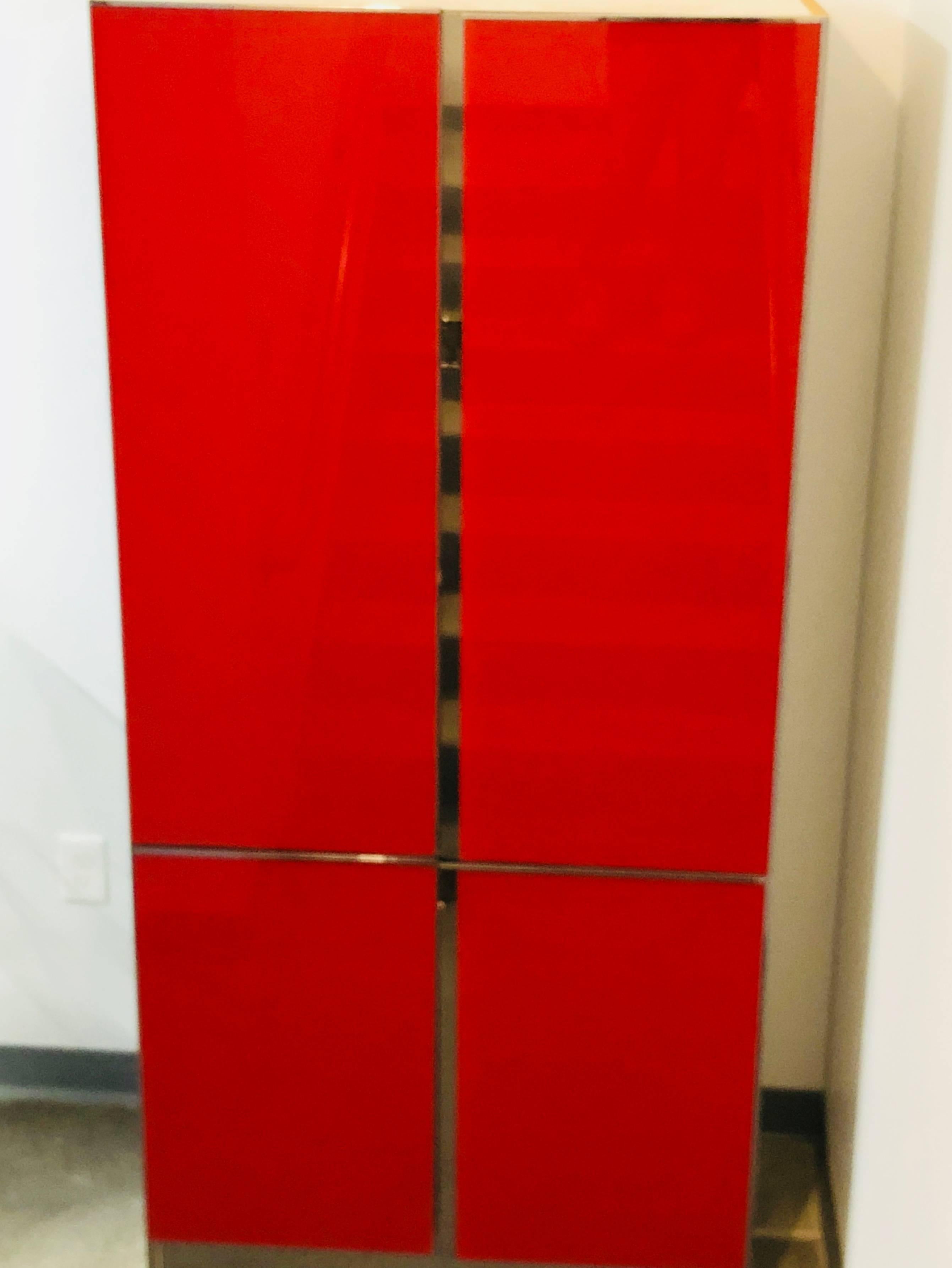 Offered is a signed with original papers Mid-Century Modern / Postmodern / contemporary Ello tall storage cabinet of red glass, chrome sides and trim and off-white laminate shelves and drawers. This Ello cabinet could have so many different uses