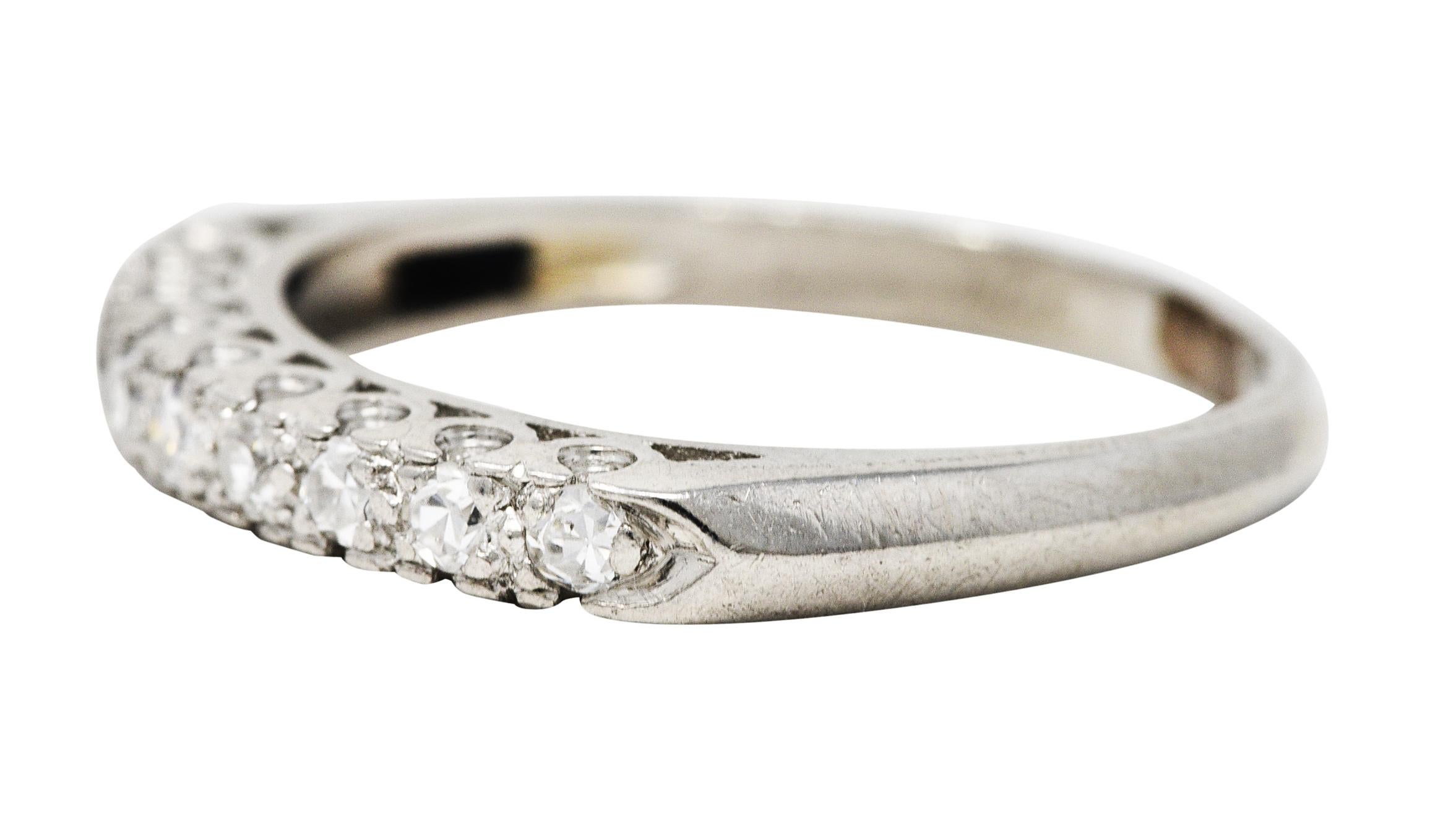 Band is set to front by single cut diamonds and flanked by pointed shoulders

Weighing in total approximately 0.25 carat - eye clean and bright

With subtle cathedral shoulders and a scooped fishtail profile motif

Inscribed and stamped for