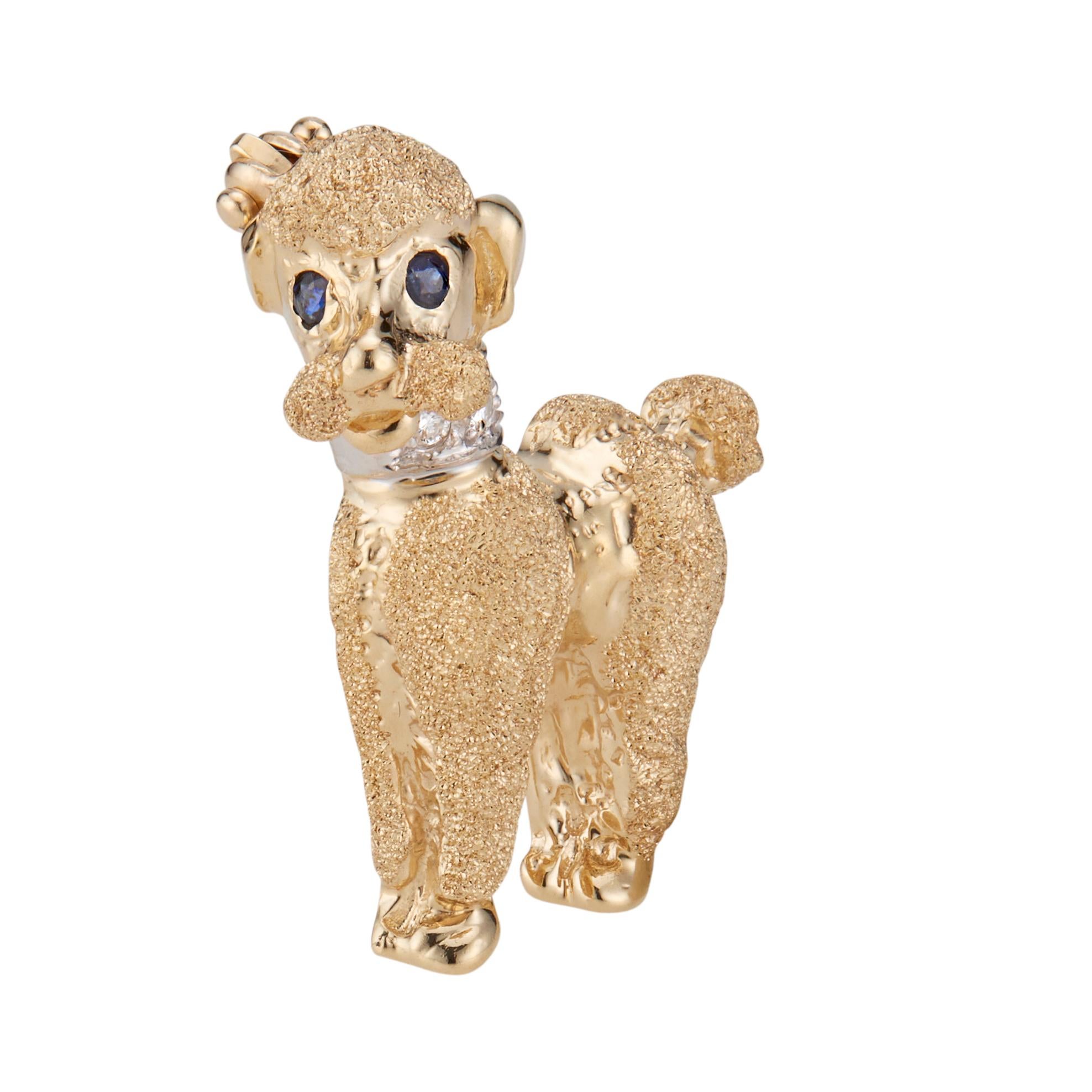 1960's Poodle brooch. Round Sapphire yes with diamond white gold collar, set in 14k gold. 

3 round full cut Diamonds, approx. total weight .03cts, H, SI
2 round blue Sapphires, approx. total weight .02cts
14k yellow gold 
14k white gold 
Tested and
