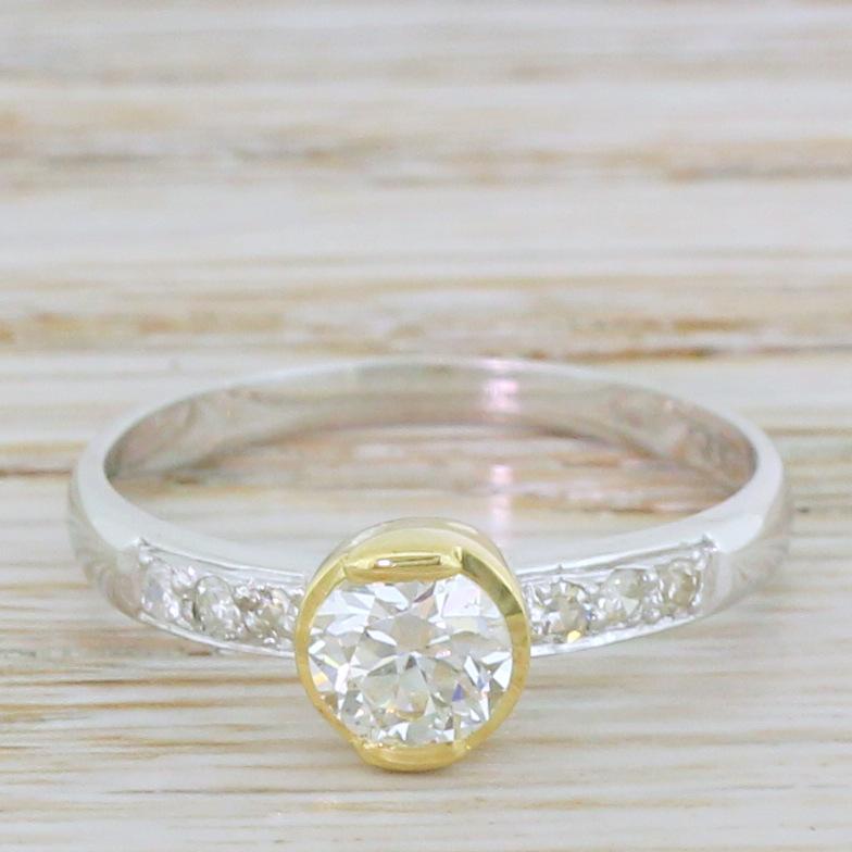 A fantastically funky old European cut solitaire ring. The centre stone is secured in a ‘half rubover’ gold collet with a closed gallery, the whiteness of the stone emphasised by the yellow gold of the setting. Six (three each side) eight-cut