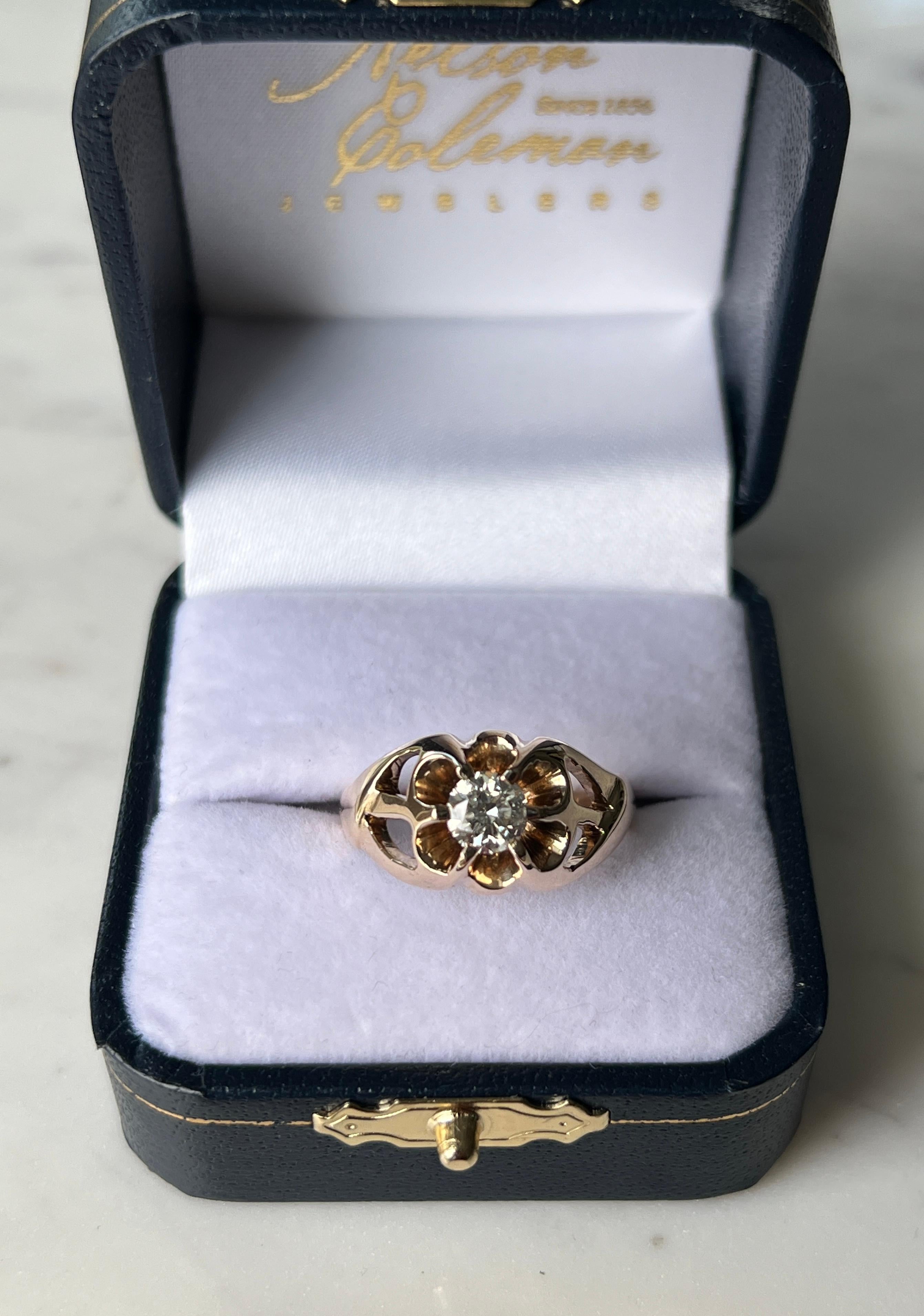 One vintage mid-century 1960s buttercup ring crafted in 14 karat yellow gold and set with a single round brilliant cut diamond weighing approximately 0.64 carats, with K color and SI2 clarity. The diamond is presented in a classic buttercup-style