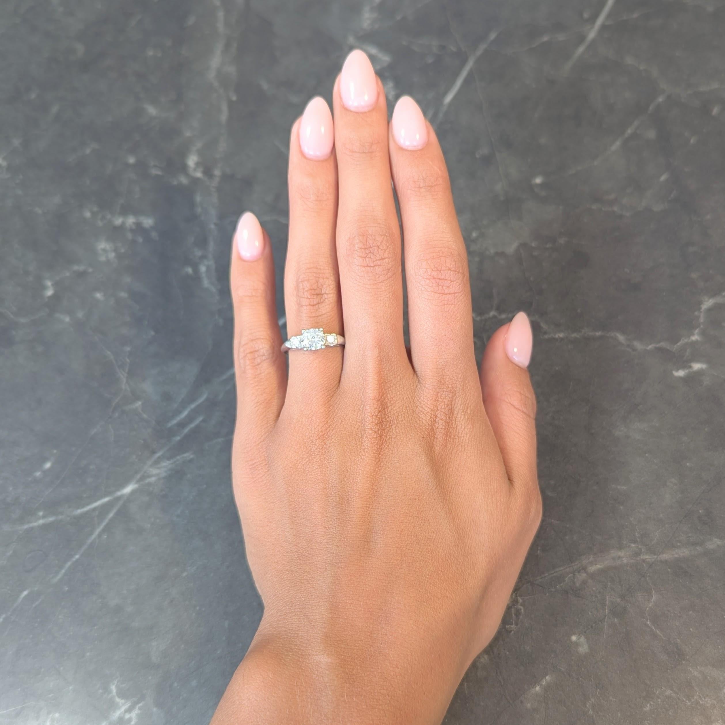 Centering a transitional cut diamond weighing approximately 0.77 carat total - J color with VS2 clarity
Set with tri-split prongs in a pierced square form basket flanked by additional diamond
Transitional cut and weighing approximately 0.08 carat