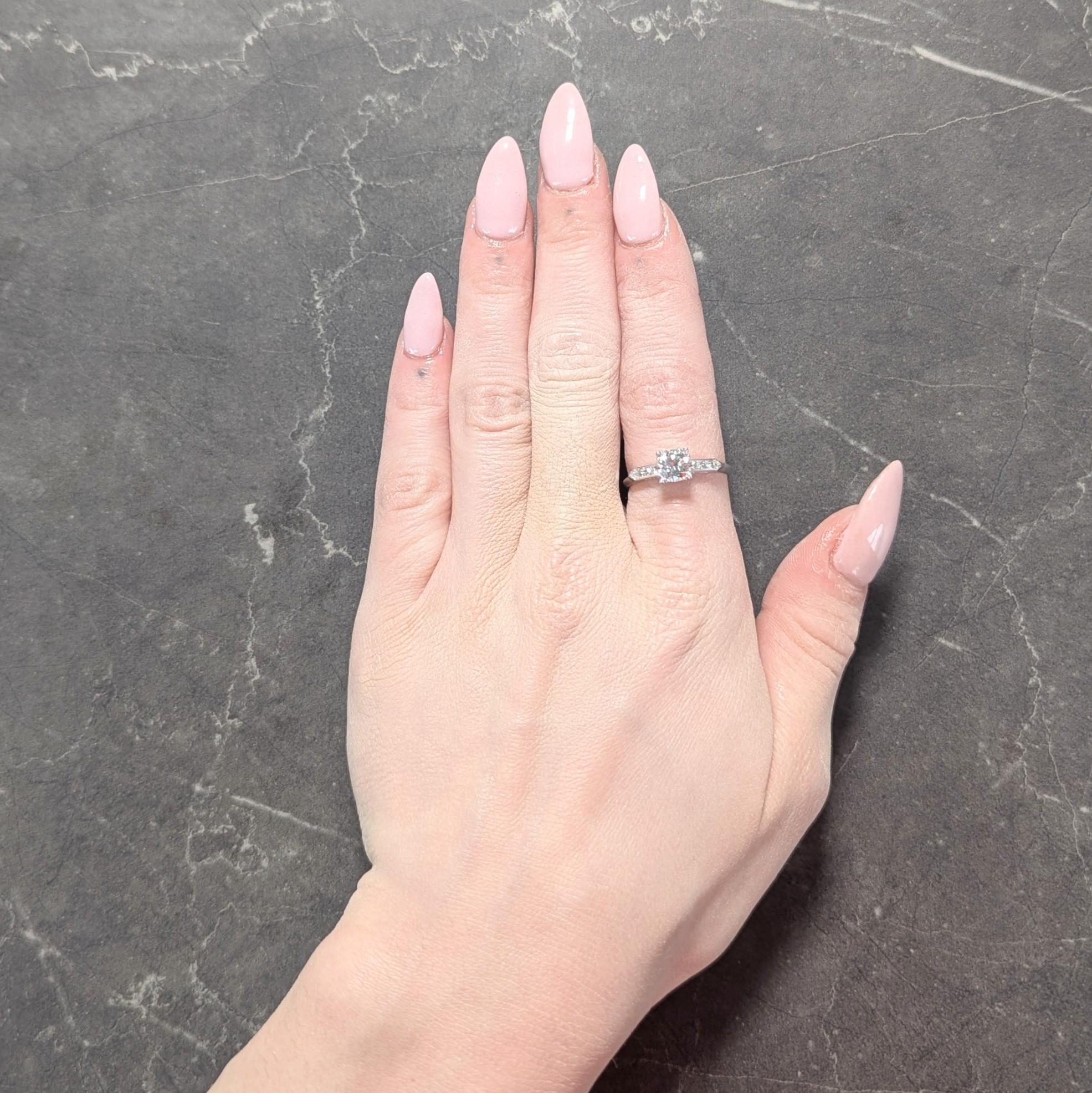 Centering a transitional cut diamond weighing approximately 0.84 carat total
J color with VS2 clarity - set with tri-beaded prongs in a pierced 'W' basket
Flanked by single cut diamonds channel set in shoulders
Weighing approximately 0.10 carat
