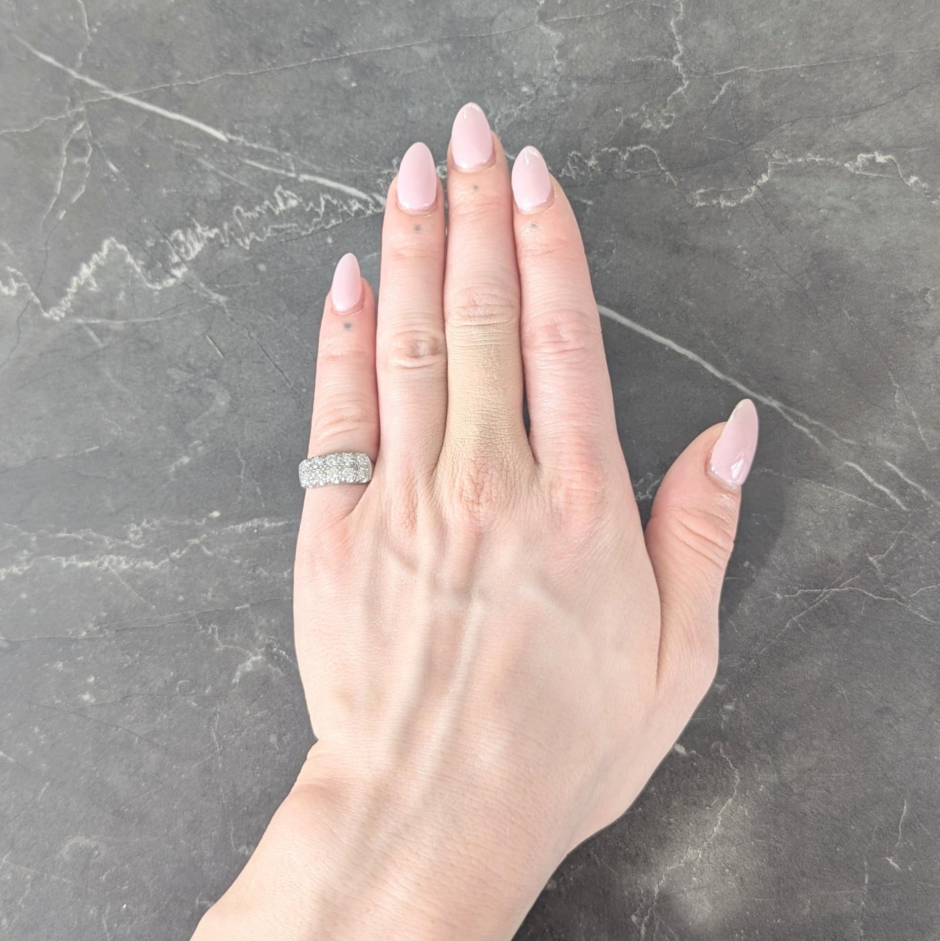 Centering two parallel rows of transitional cut diamonds set to front with fishtail prongs
Weighing approximately 1.00 carats total - G/H color with VS2 clarity
Accented by grooved crosshatch pattern in-between
Stamped for 14 karat gold
With maker's