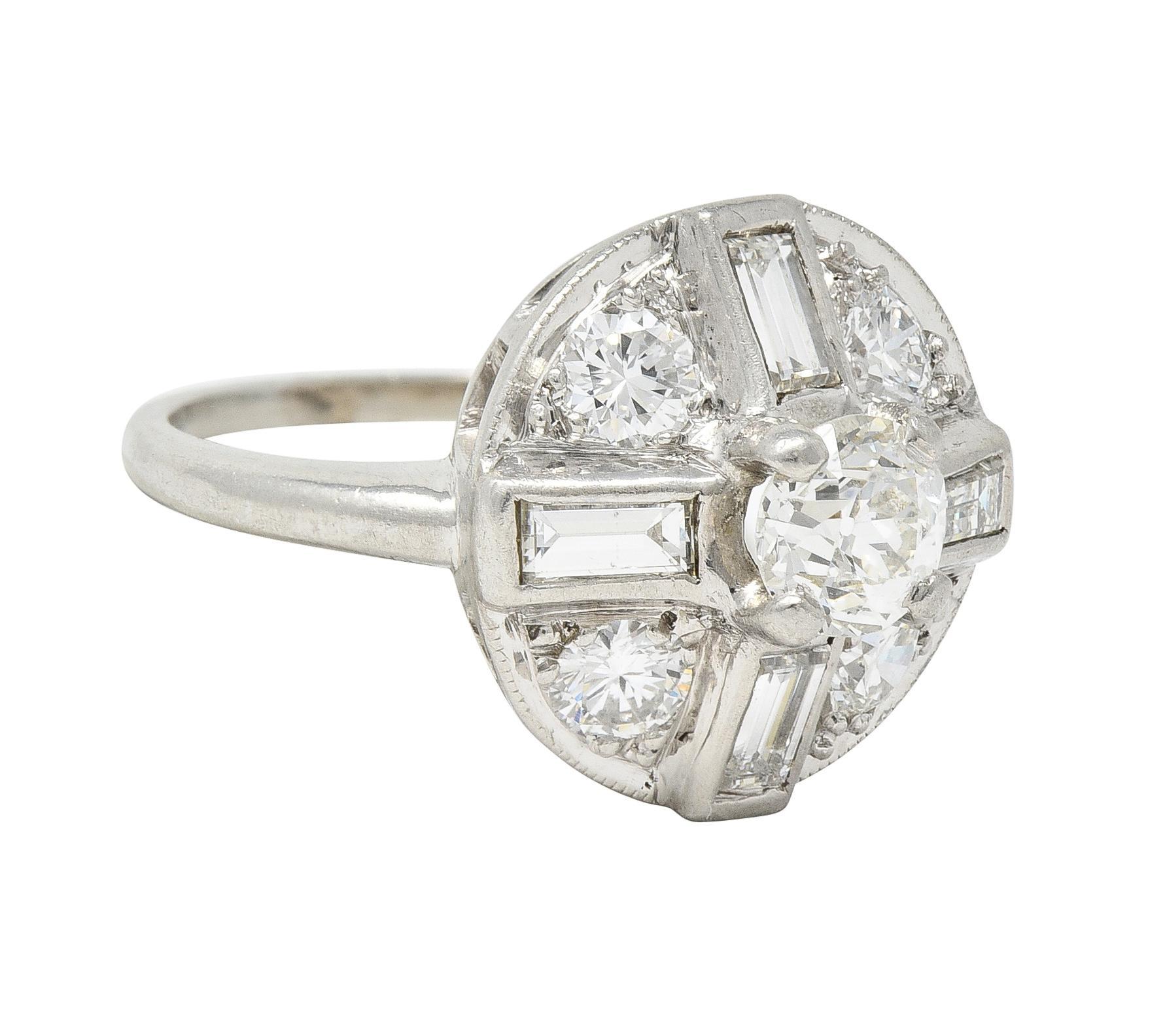 Centering an old European cut diamond weighing approximately 0.36 carat 
J with VS2 clarity - prong set with a recessed circular surround 
Comprised of transitional and baguette cut diamonds 
Arranged as a cross motif and weighing approximately 0.64