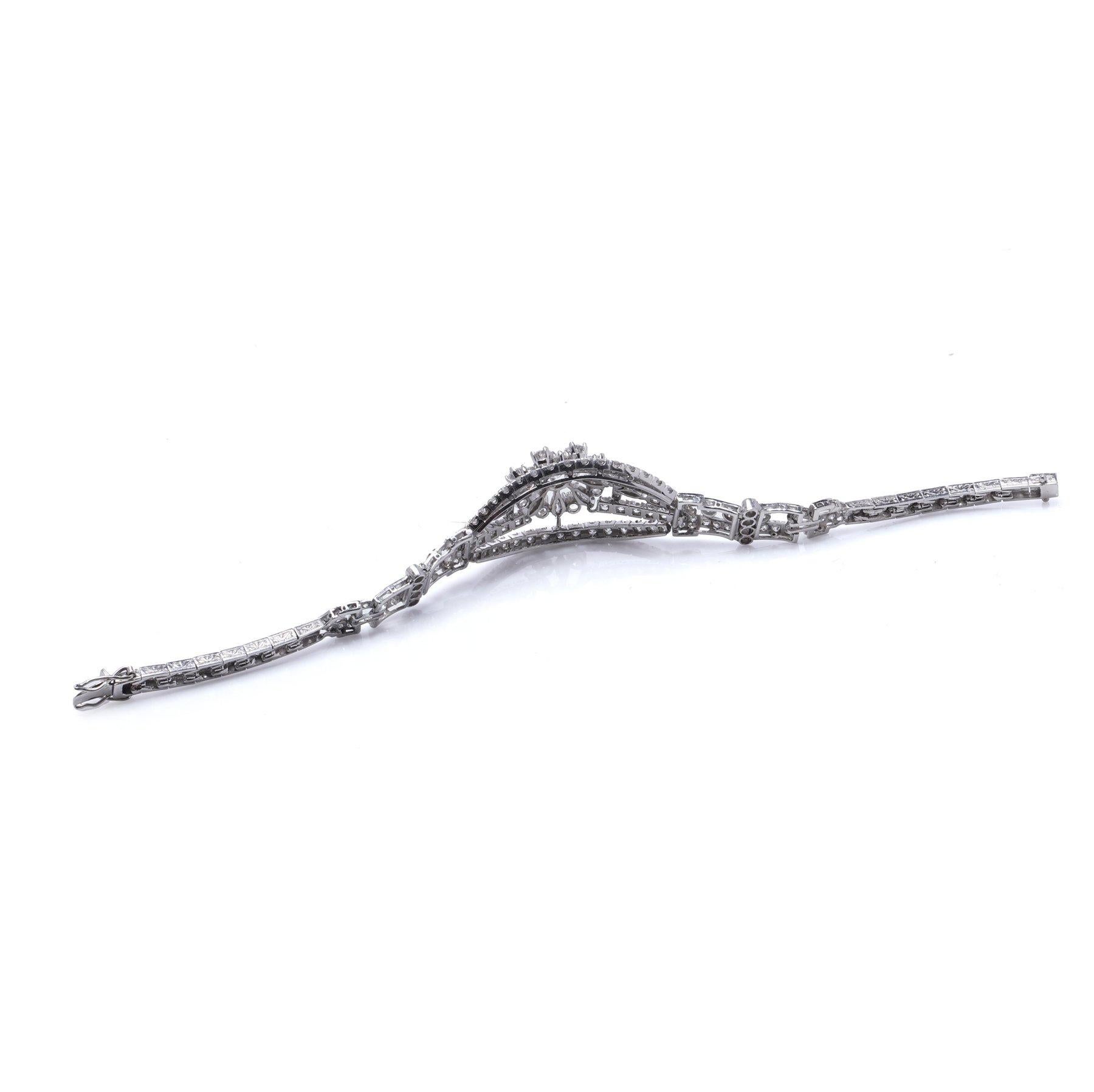 Mid-Century 10.00 carat diamond bracelet in 18K White Gold & Platinum, Circa 1950s. 

A striking mid-century diamond bracelet, crafted in 18K white gold with platinum links, showcasing a highly articulated design. The bracelet's central motif is an