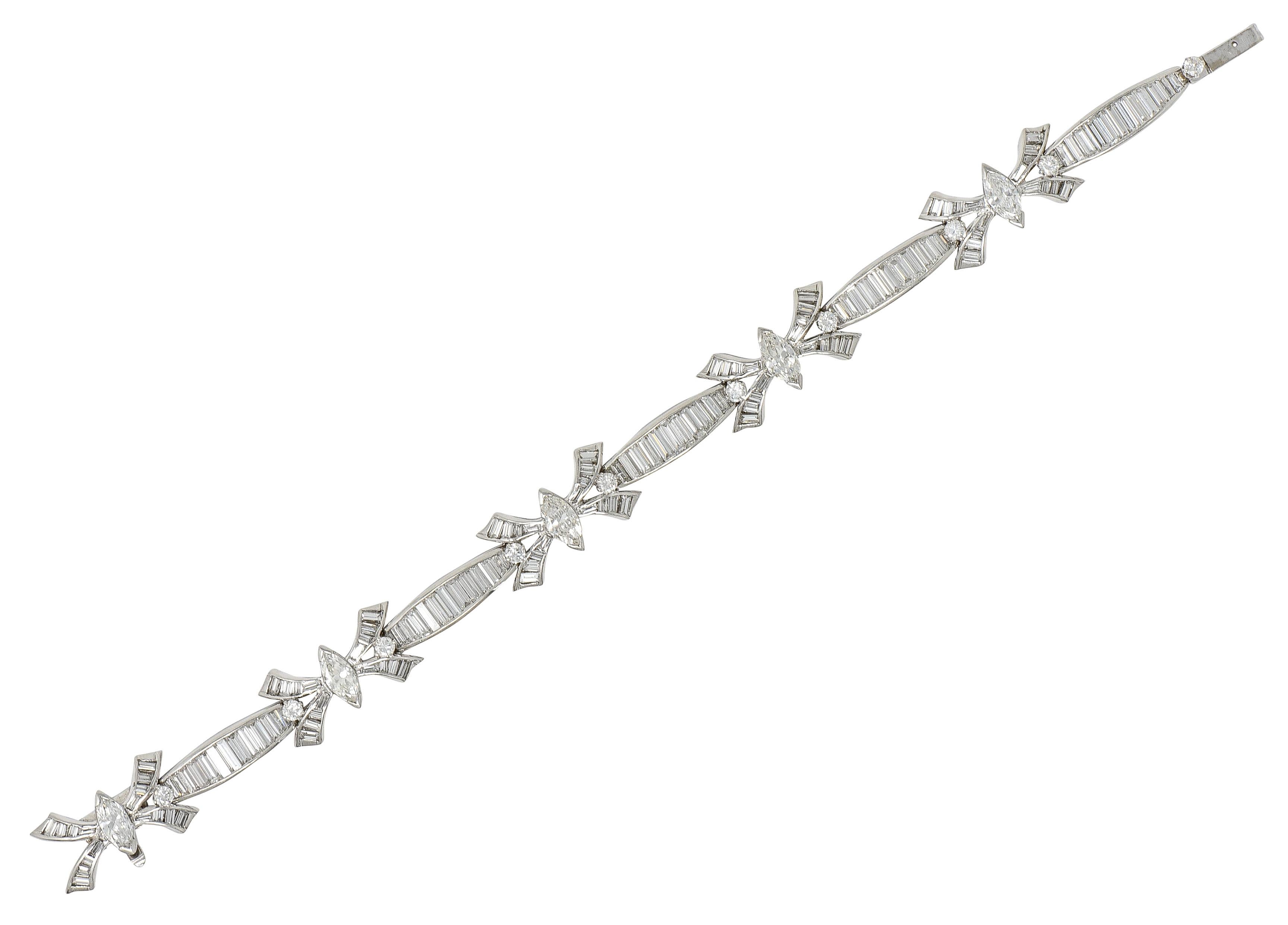 Comprised of hinged navette and 'X' shaped ribbon motif links featuring marquise cut diamonds. Set North to South with tab-like prongs and centered on 'X' shaped links. Weighing approximately 1.90 carats total - G to I in color with VS clarity.