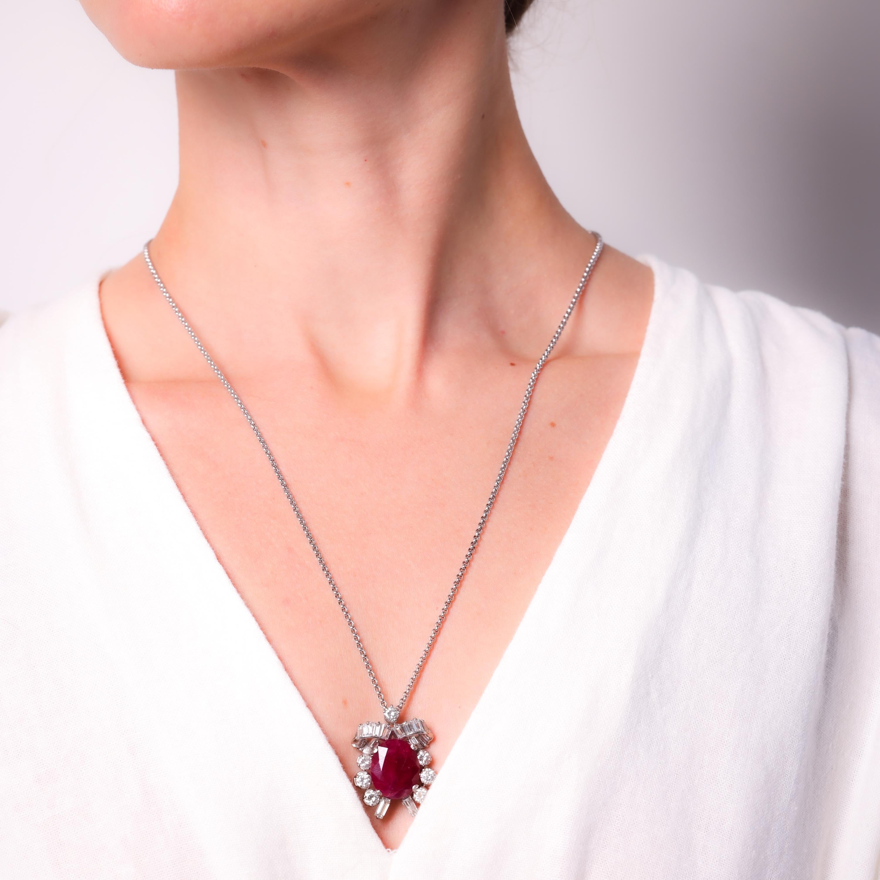 Certificate: Gubelin #18060213
Center Stone: Oval Cut Ruby
Weight: Approximately 11.6 Carat
Origin: Burma 
Treatment(s): None 
Total Diamond Weight: Approximately 5 Carats
Accent Stone: 25 Round Brilliant, Transitional, and Baguette Cut