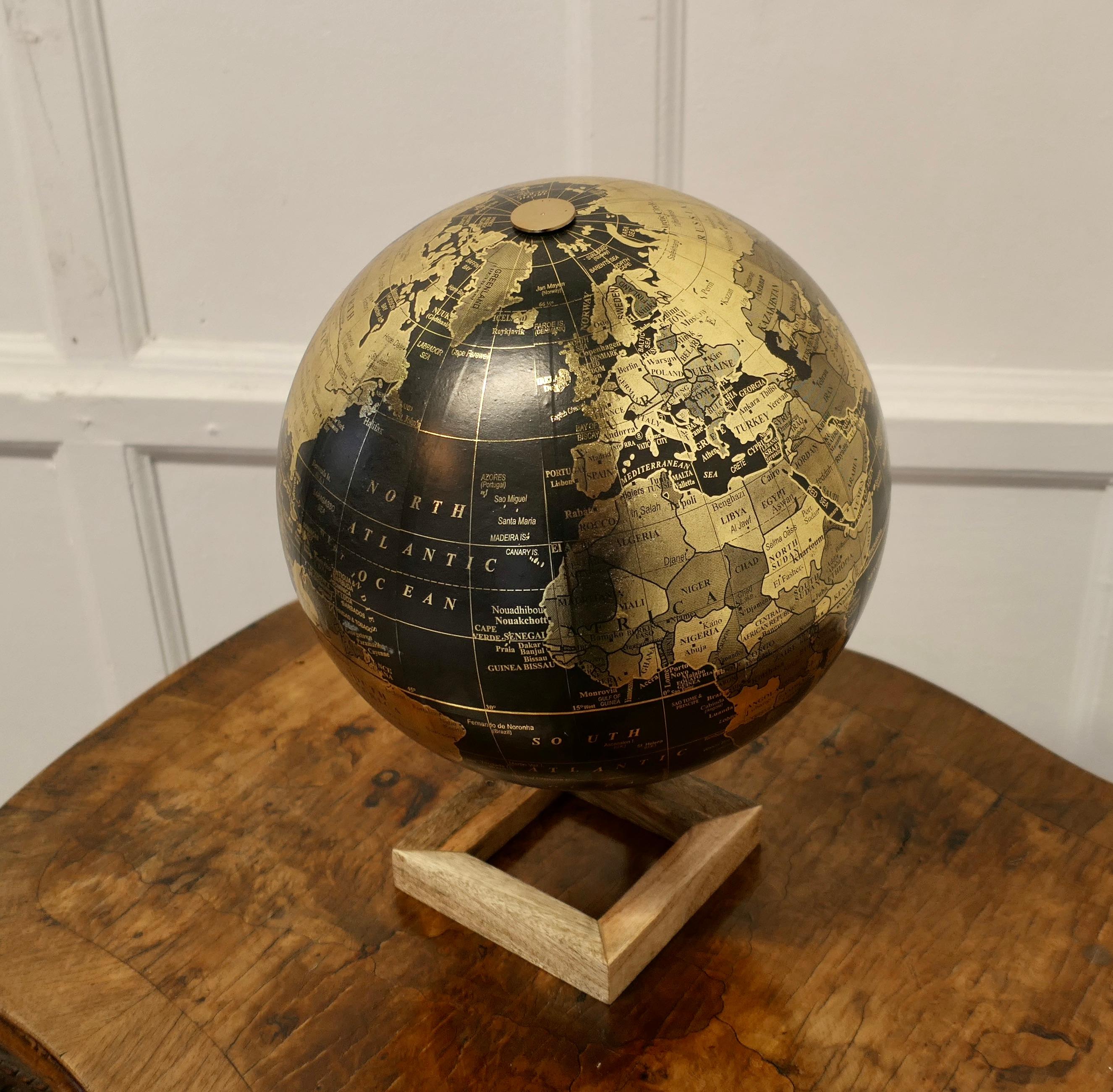 Mid Century 12” Terrestrial Black and Gold Globe  

This is an unusual colour presentation for a globe, this is a Mid Century piece, the sea is in Black and the land is in Gold, the globe is fully revolving  
The Globe is in good condition for its