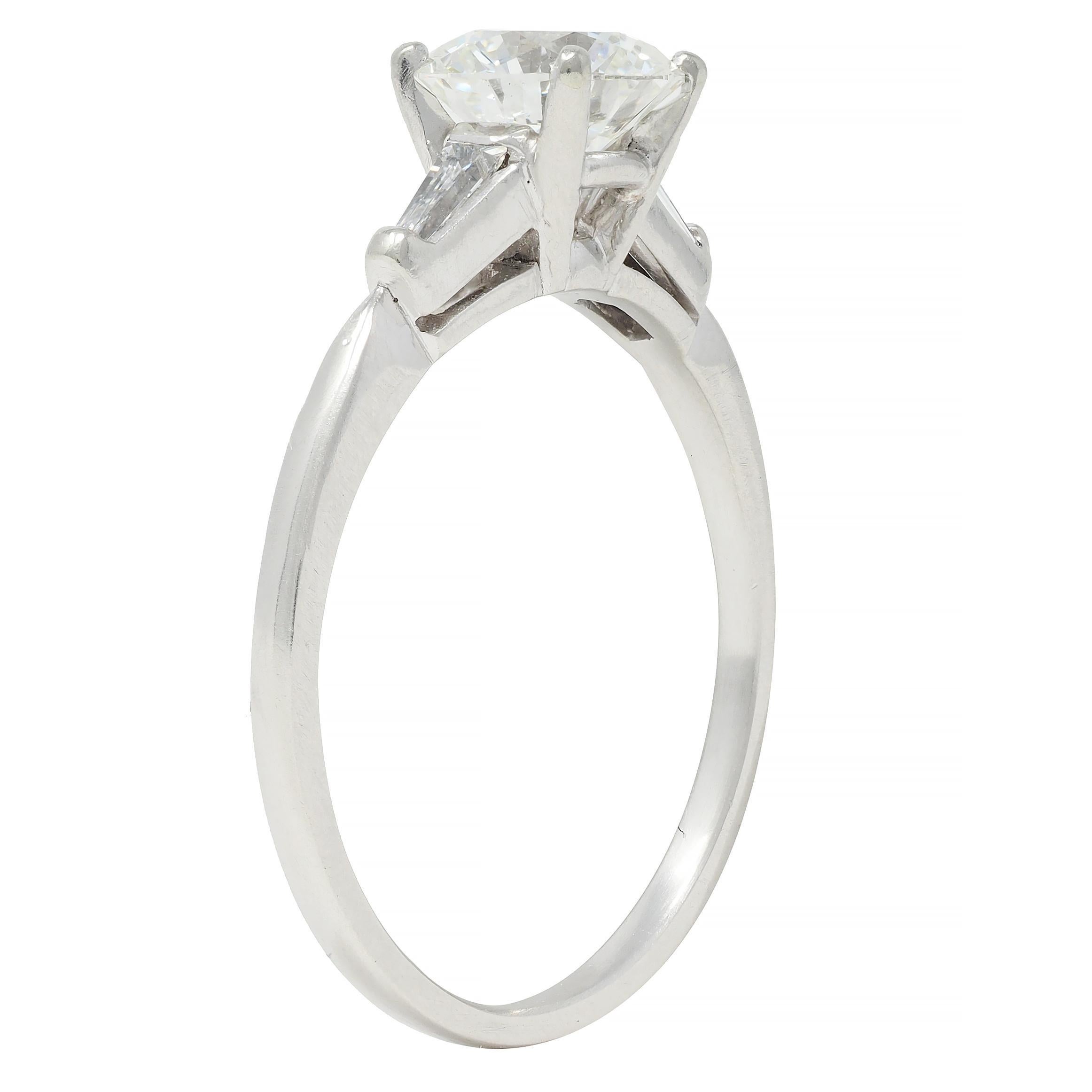 Centering a transitional cut diamond weighing approximately 1.04 carats - H color with VS2 clarity
Prong set in basket and flanked by cathedral shoulders bar set with baguette cut diamonds
Weighing approximately 0.18 carat total - eye clean and