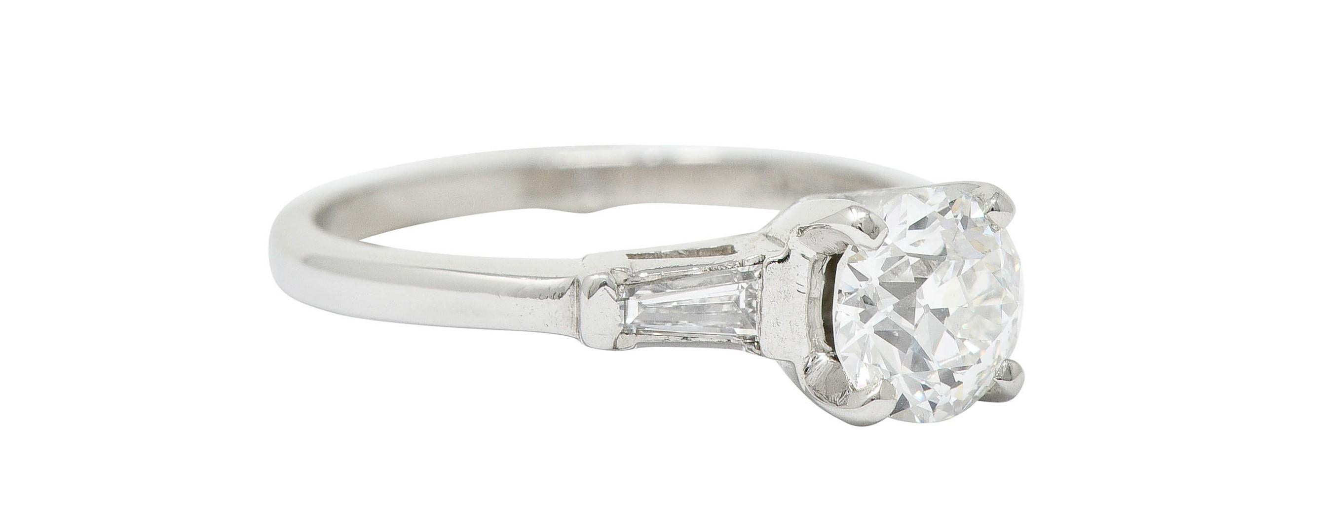 Centering an old European cut diamond weighing 1.06 carats - G color with VS1 clarity

Flanked by two tapered baguette cut diamonds weighing in total approximately 0.20 carat - well matched to center

Stamped for platinum

Maker's mark for United